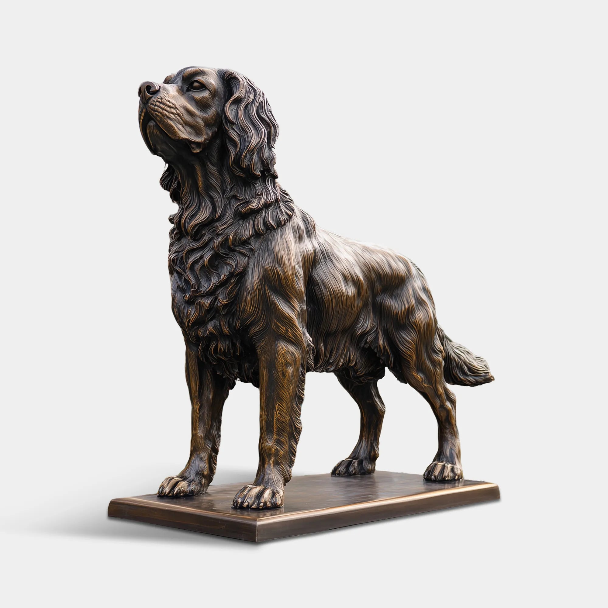 Bronze standing dog statue on a stone patio in front of a historic estate garden and manor house.