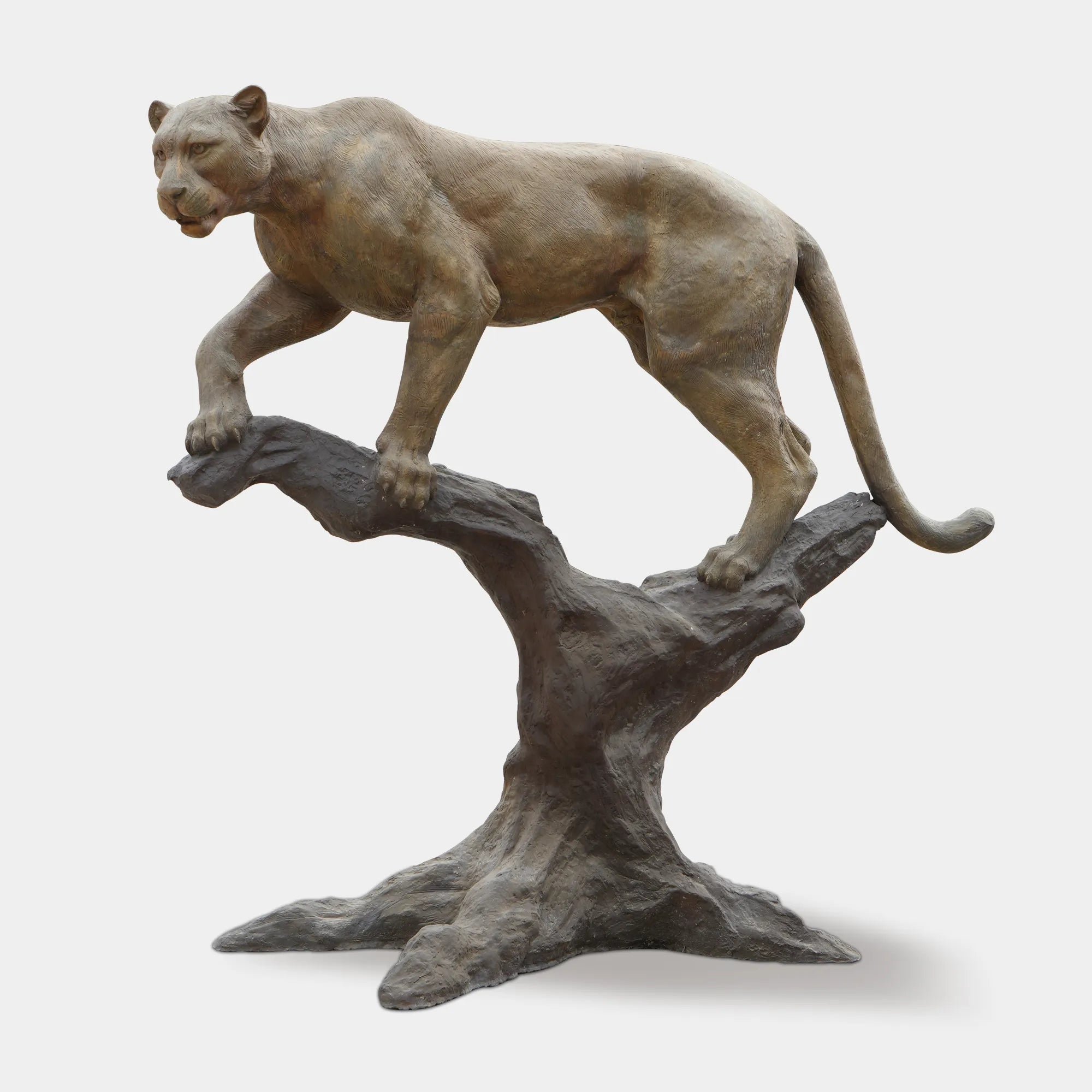 Full view of bronze panther sculpture standing on a tree branch showing lifelike pose.