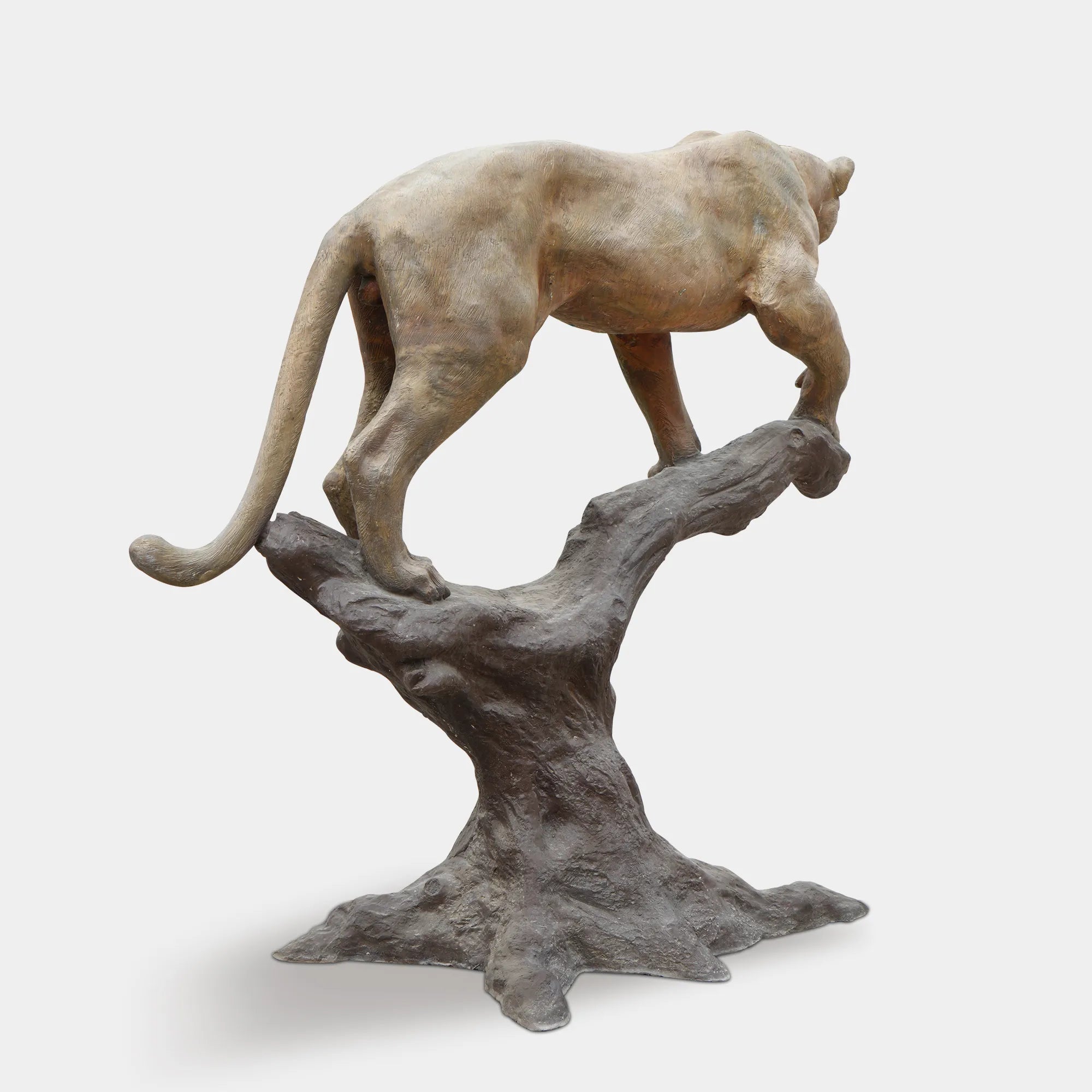 Full view of bronze panther sculpture standing on a tree branch showing lifelike pose.