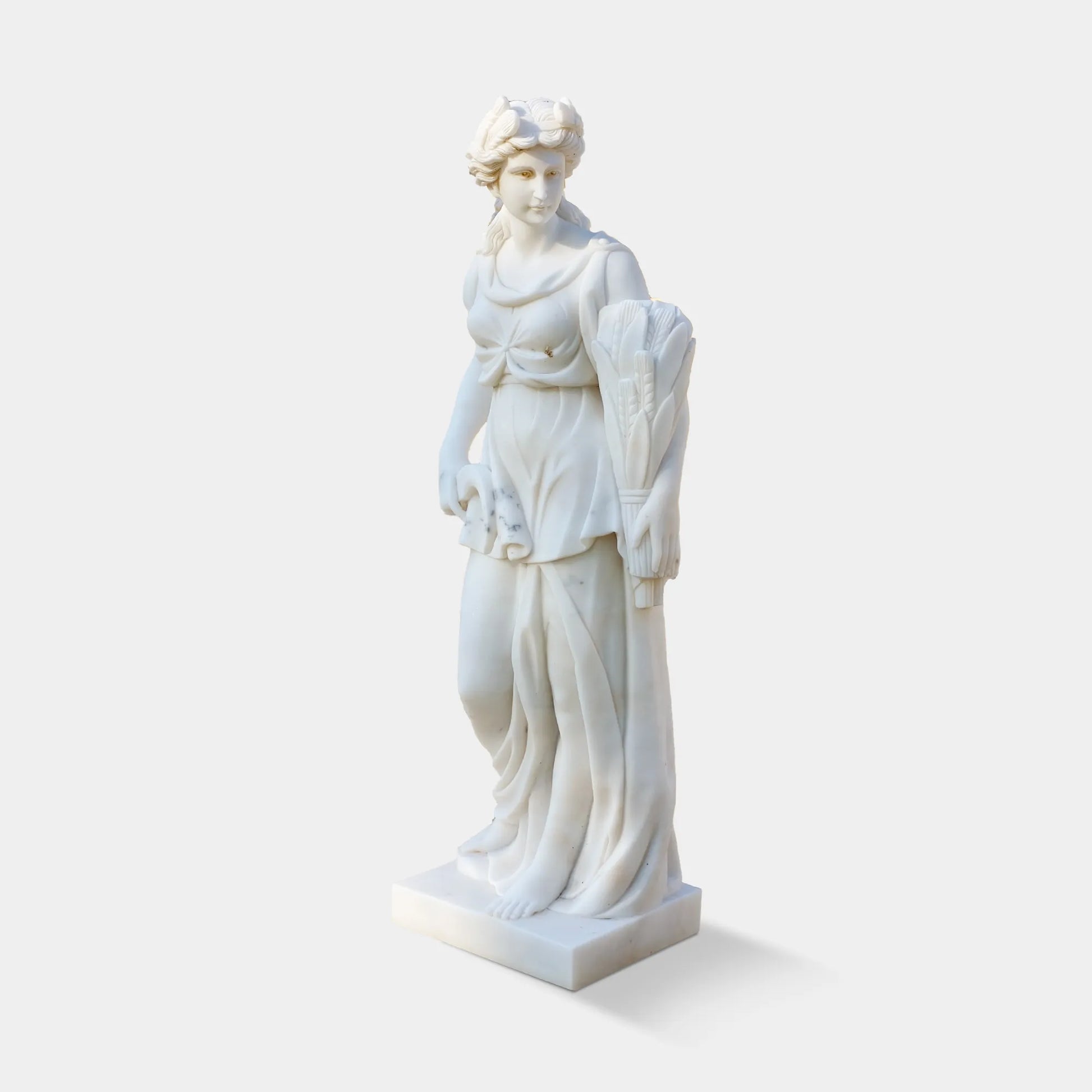 Marble sculpture of the Goddess of Harvest holding wheat, a symbol of abundance and fertility, ideal for garden settings.