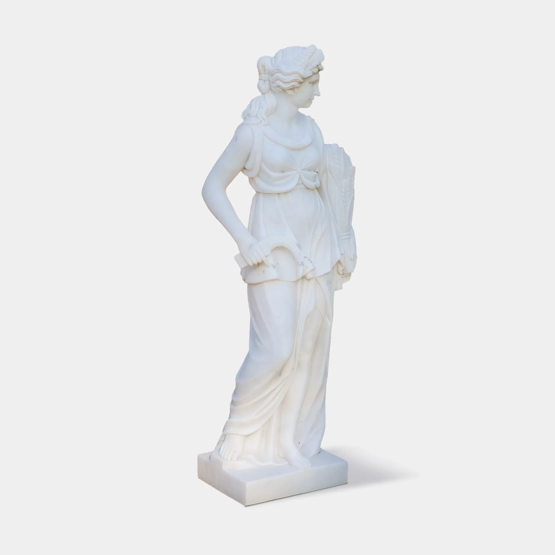 Marble sculpture of the Goddess of Harvest holding wheat, a symbol of abundance and fertility, ideal for garden settings.