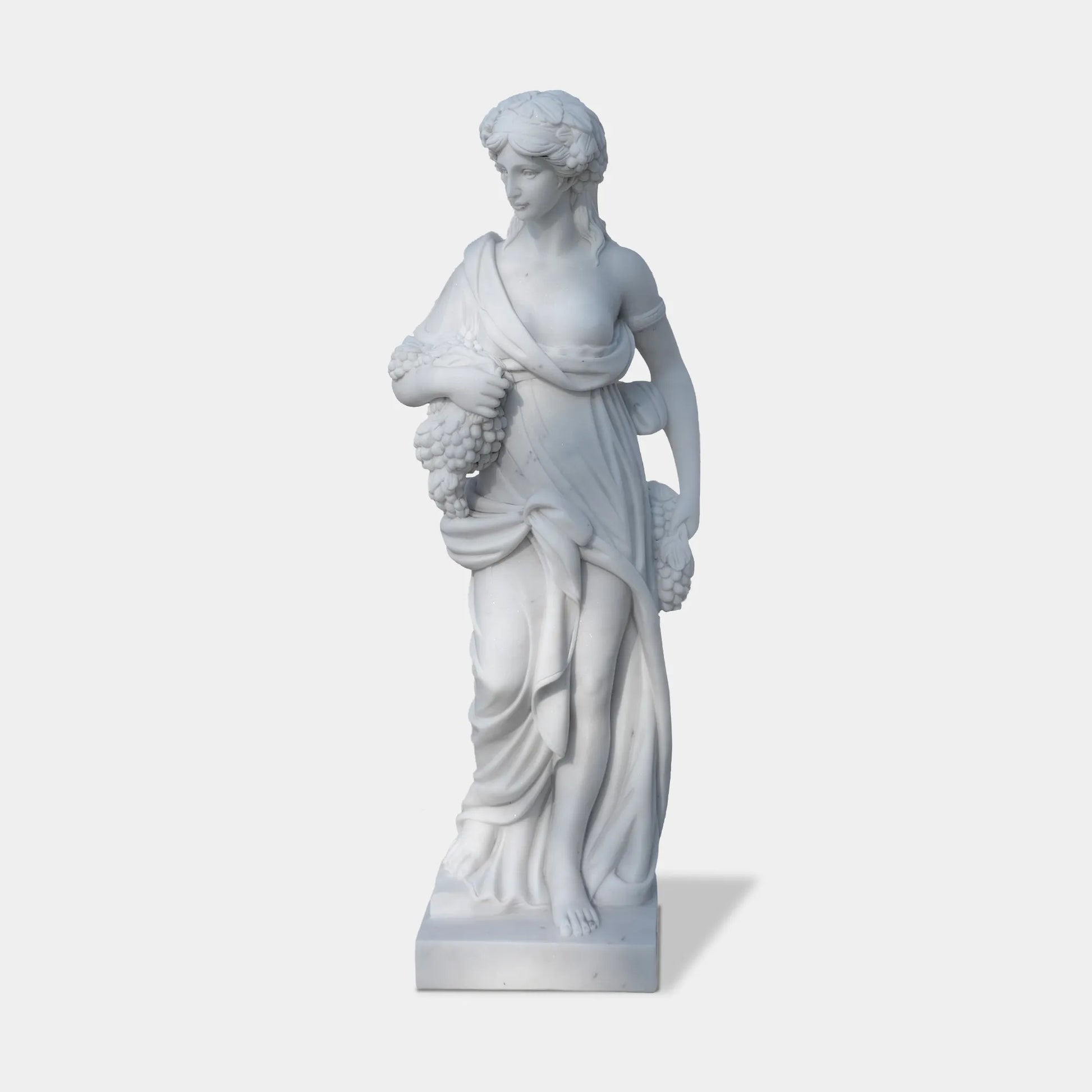Marble sculpture of the Goddess of Abundance holding grapes, symbolizing fertility and prosperity, ideal for villa courtyards, gardens, and cultural spaces.