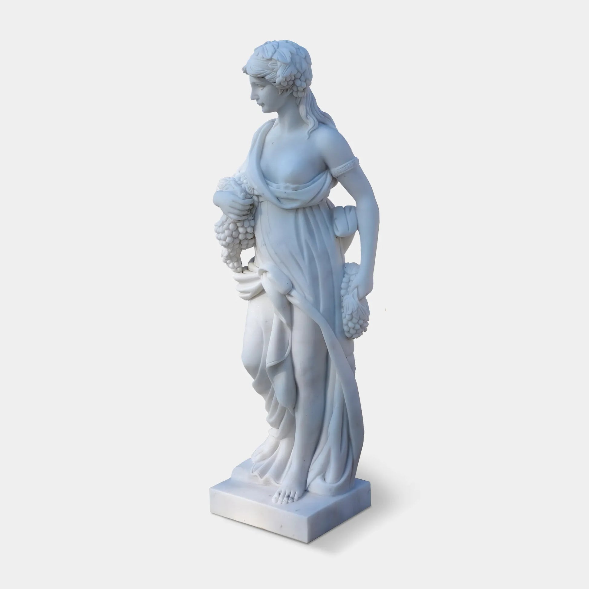Marble sculpture of the Goddess of Abundance holding grapes, symbolizing fertility and prosperity, ideal for villa courtyards, gardens, and cultural spaces.