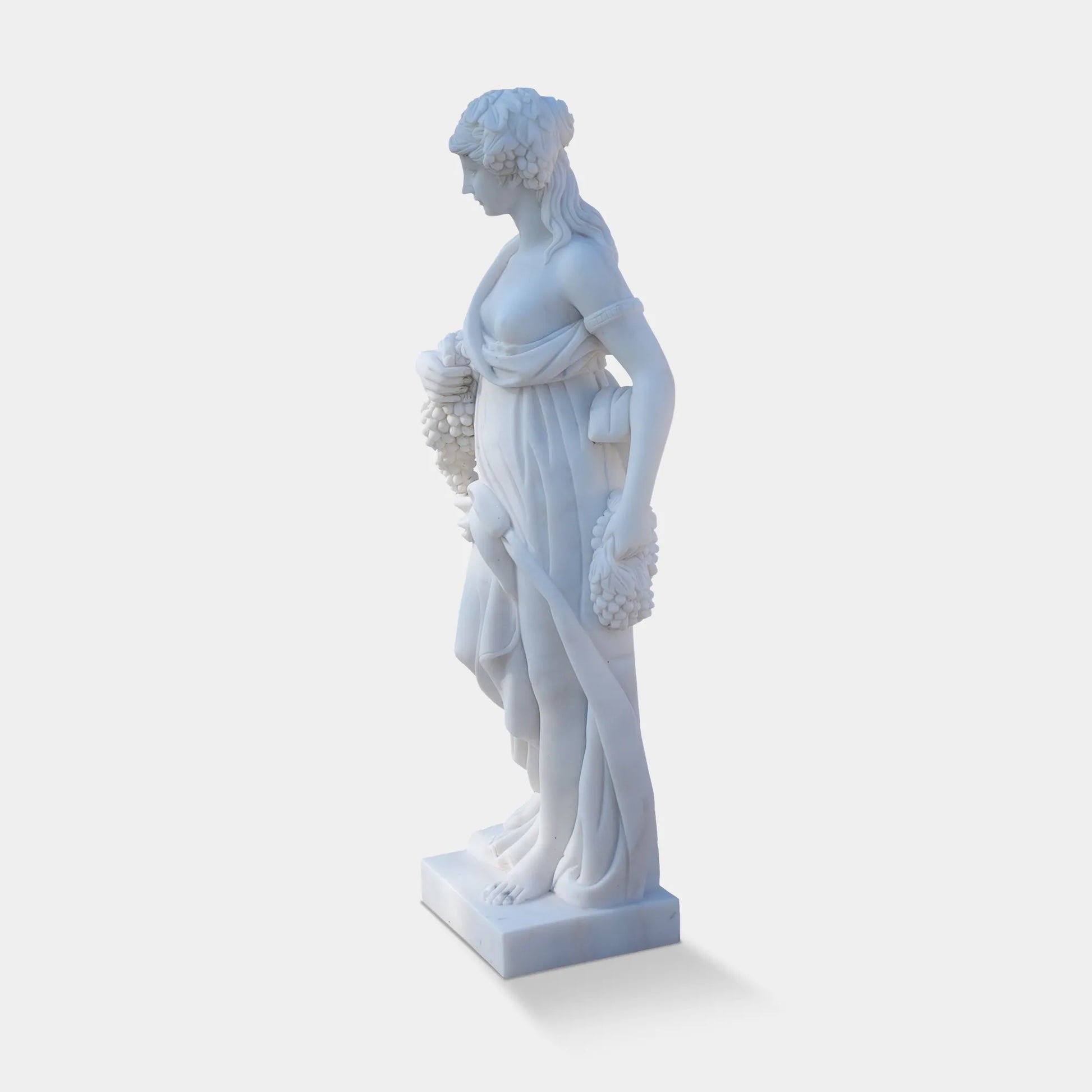 Marble sculpture of the Goddess of Abundance holding grapes, symbolizing fertility and prosperity, ideal for villa courtyards, gardens, and cultural spaces.