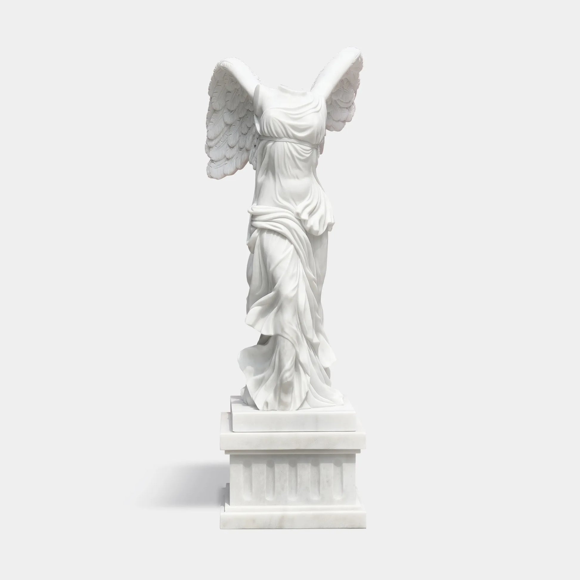 Classical marble sculpture of the Winged Victory of Samothrace with flowing drapery and soaring wings for luxury villas, courtyards, and art galleries.