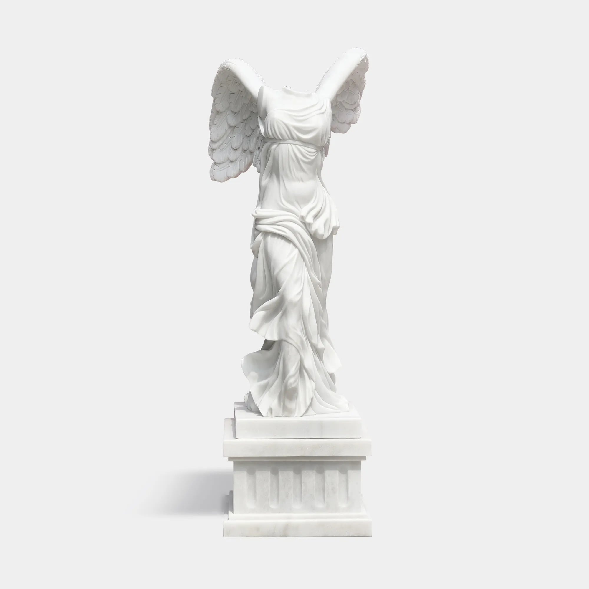 Classical marble sculpture of the Winged Victory of Samothrace with flowing drapery and soaring wings for luxury villas, courtyards, and art galleries.