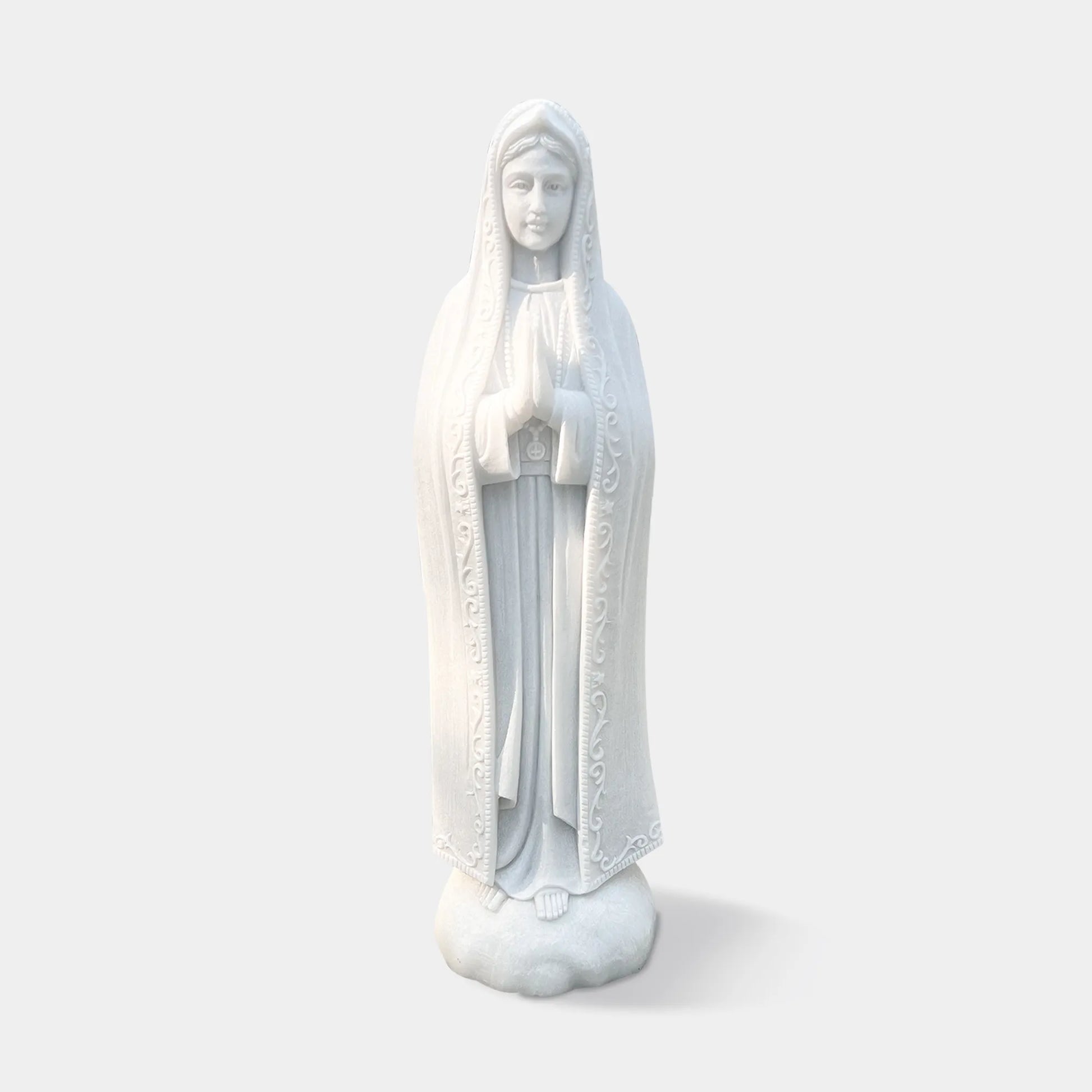 Classical marble statue of Our Lady of Fátima with flowing robe and serene expression for devotional settings in churches, chapels, and sacred gardens.