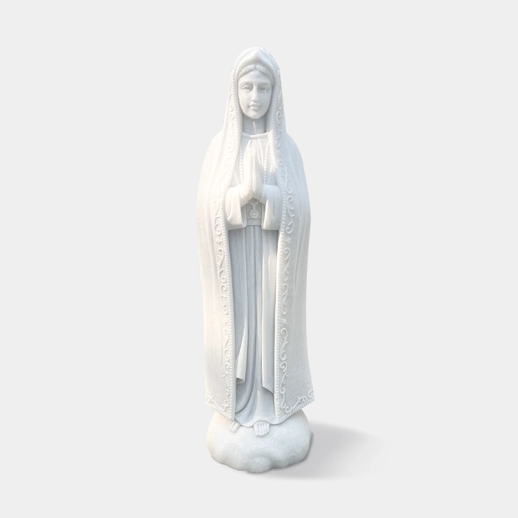 Classical marble statue of Our Lady of Fátima with flowing robe and serene expression for devotional settings in churches, chapels, and sacred gardens.