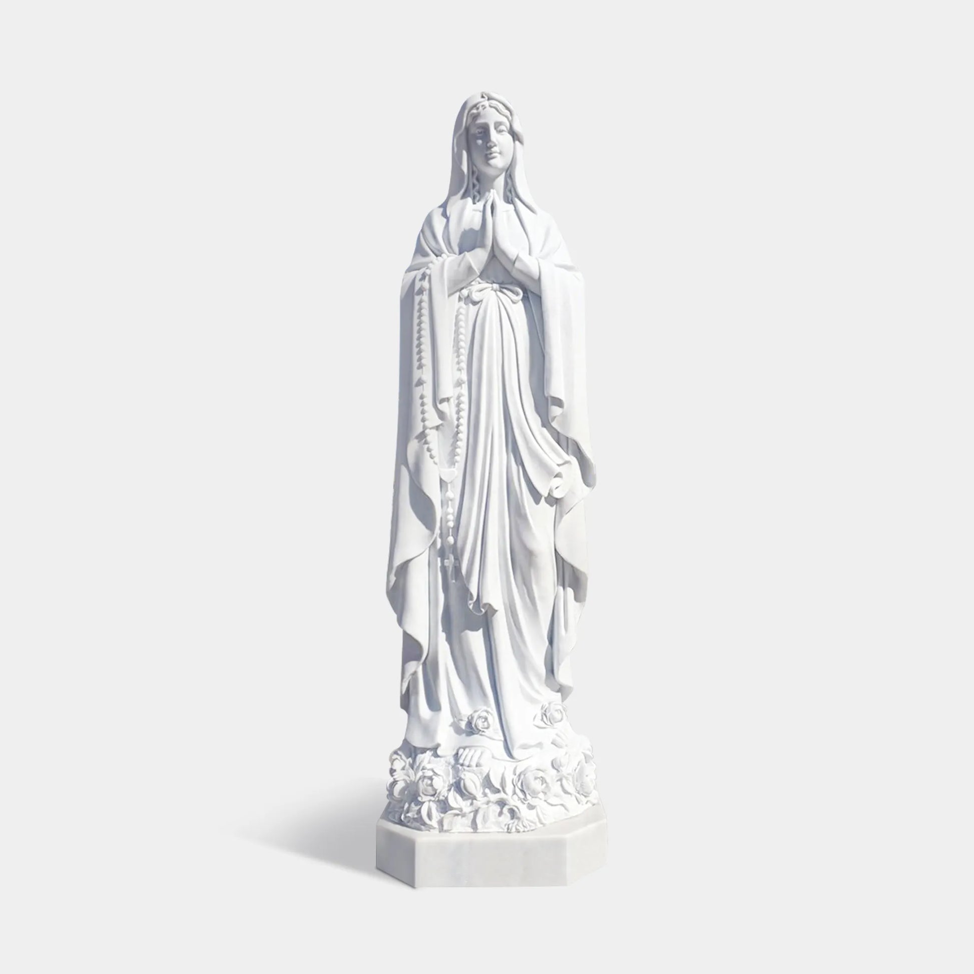 Classical marble sculpture of Virgin Mary with serene expression and flowing robes for religious settings in churches, chapels, and sacred gardens.