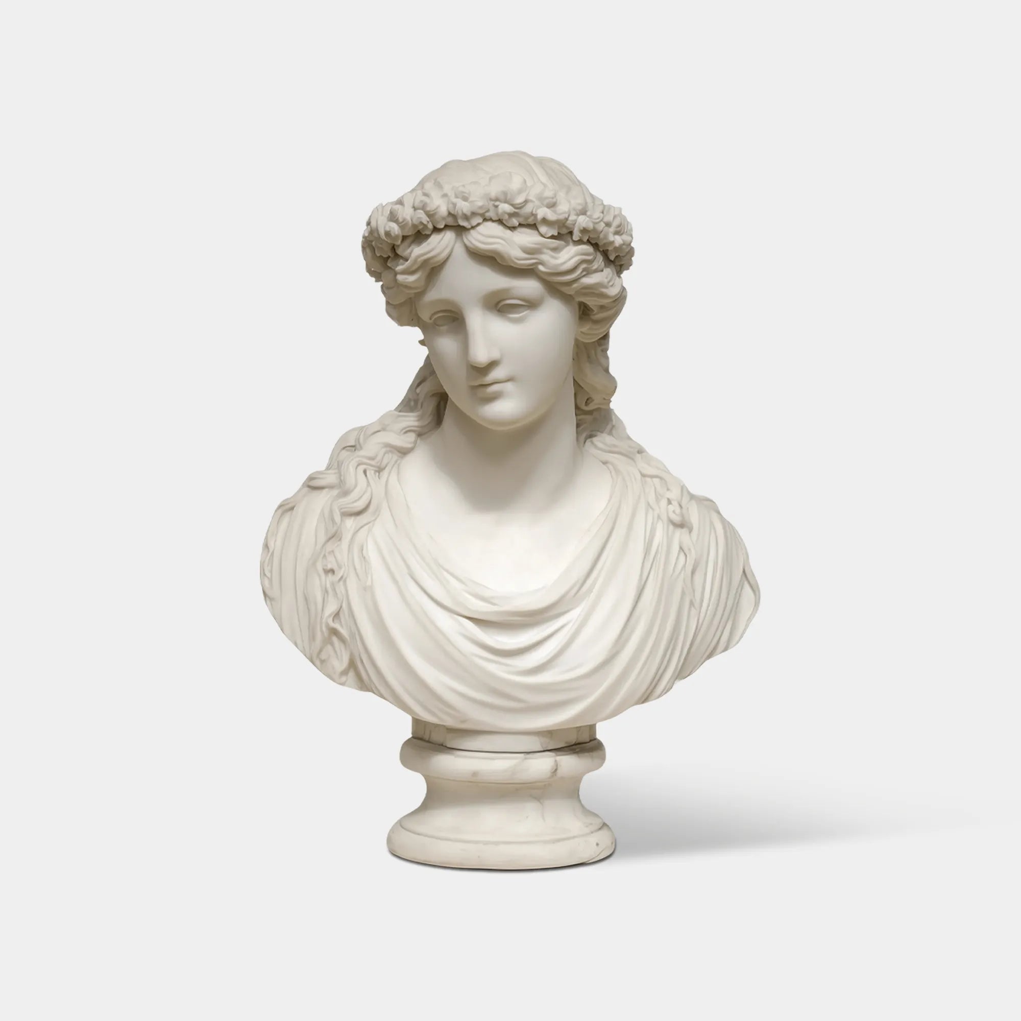 Marble bust of an elegant woman wearing a floral crown, suitable for luxury villas and interiors.