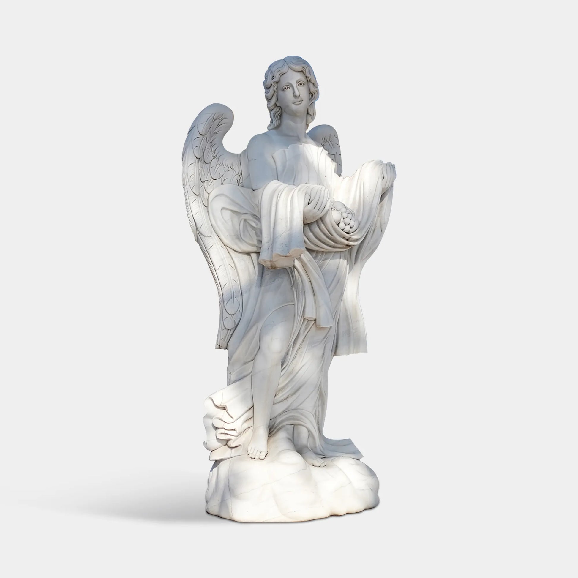 White marble angel sculpture hand-carved with wings and a draped cloth holding offerings, placed in front of a classical stone building.
