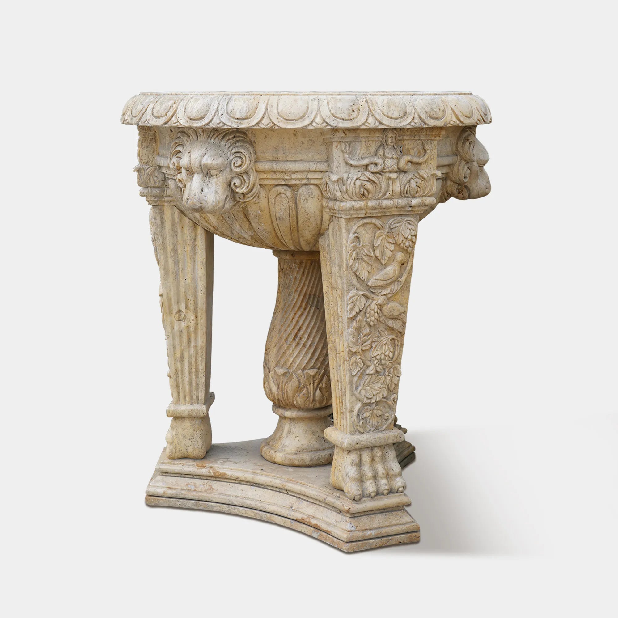A finely crafted marble jardiniere sculpture with elegant lion heads and classical floral motifs. 
