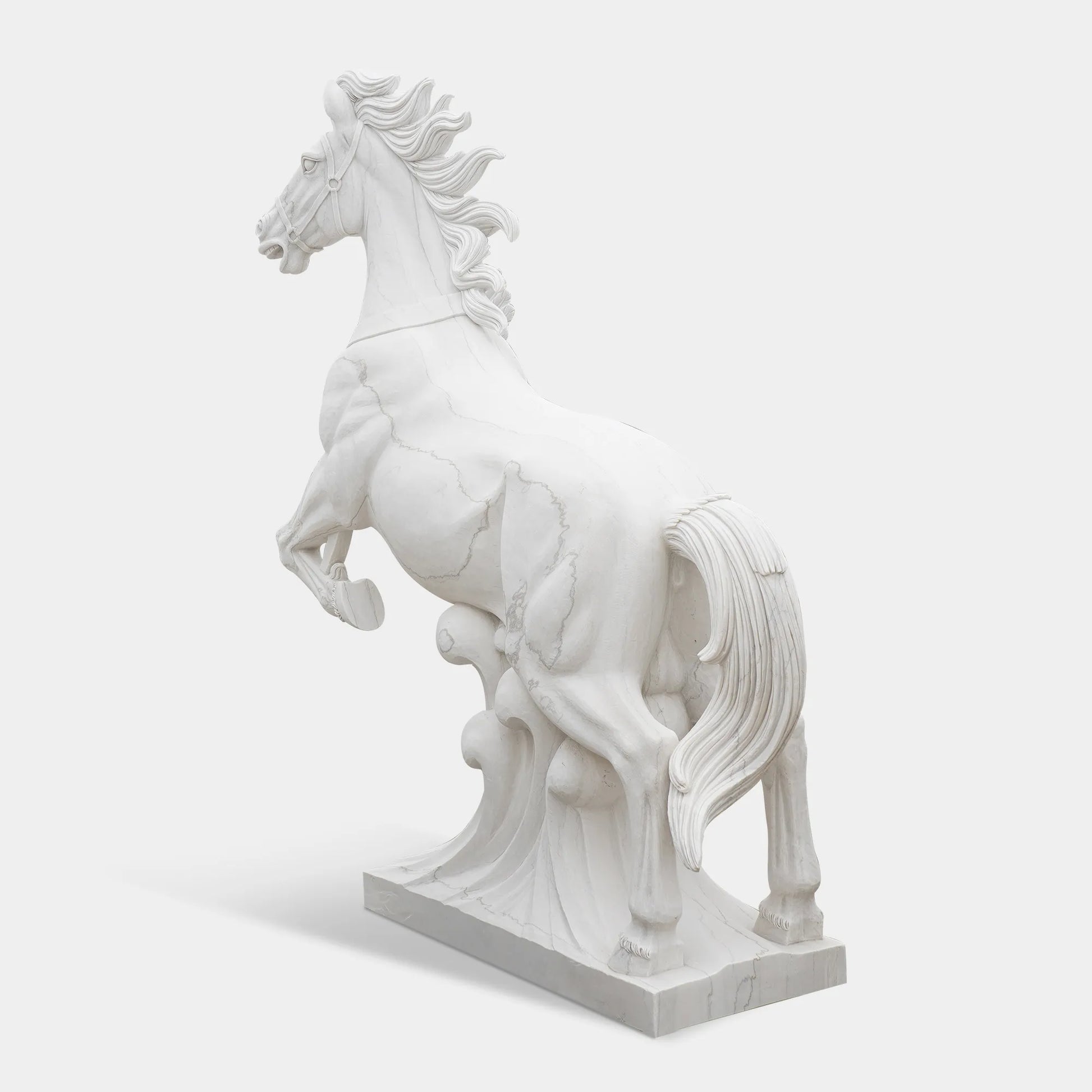 Marble horse sculpture displayed on a pedestal outside a neoclassical building under clear sky.