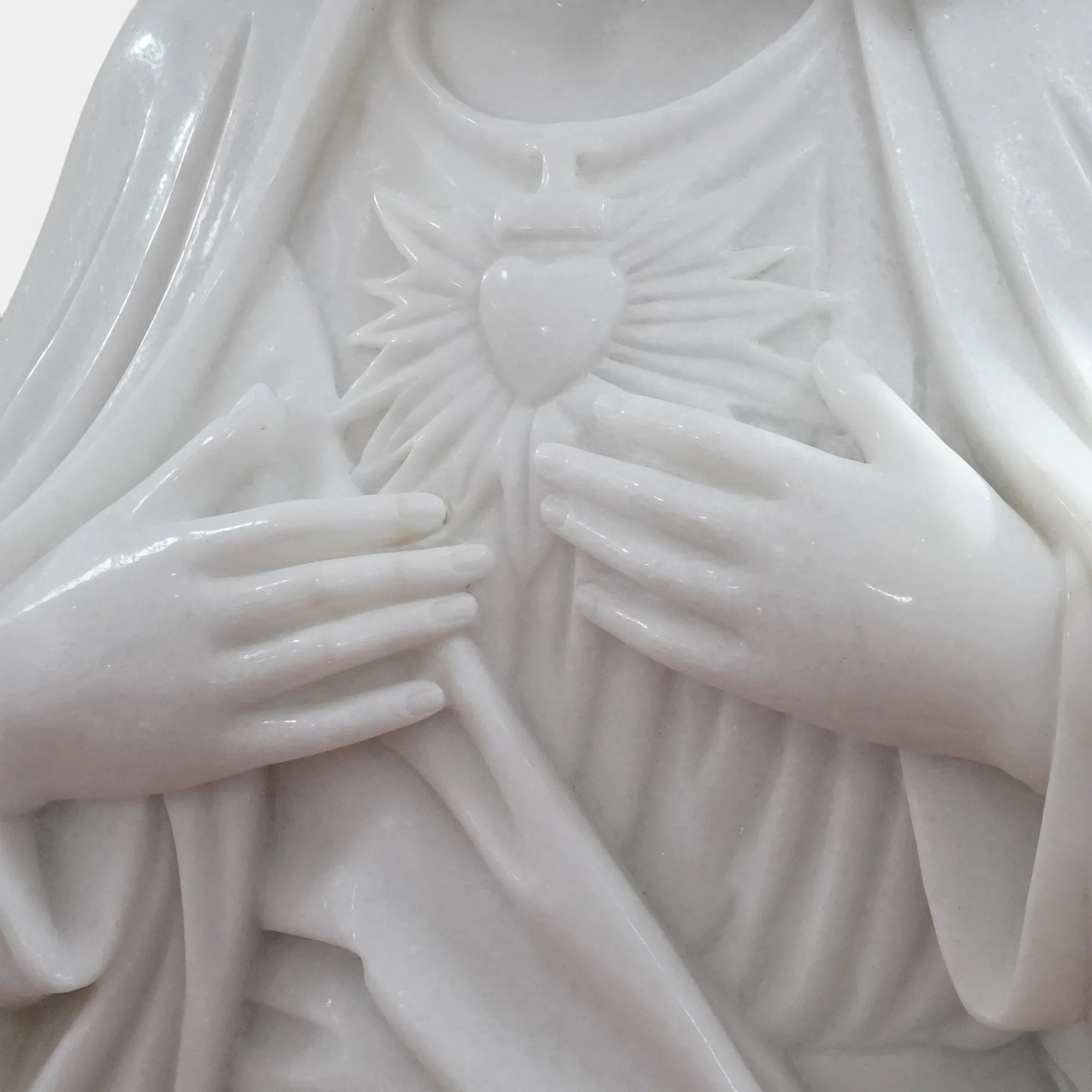 Marble Virgin Mary statue displayed in a peaceful garden surrounded by trees and classical white columns.