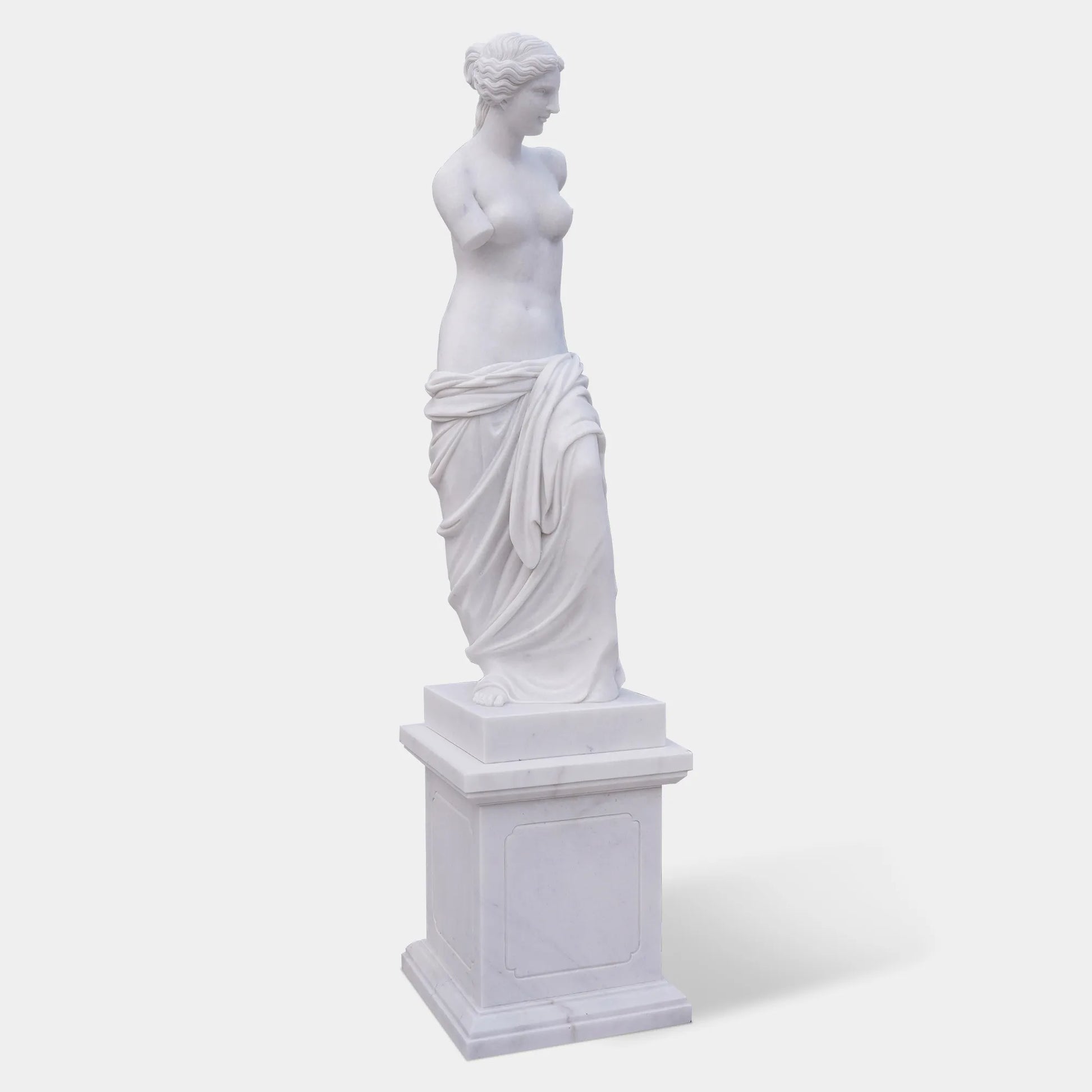 Marble sculpture of Venus de Milo with detailed Greek design standing on a pedestal.