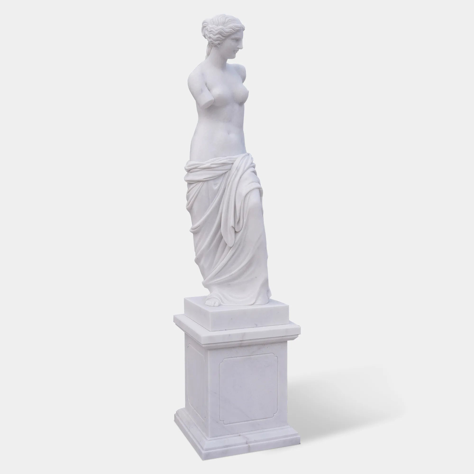 Marble sculpture of Venus de Milo with detailed Greek design standing on a pedestal.