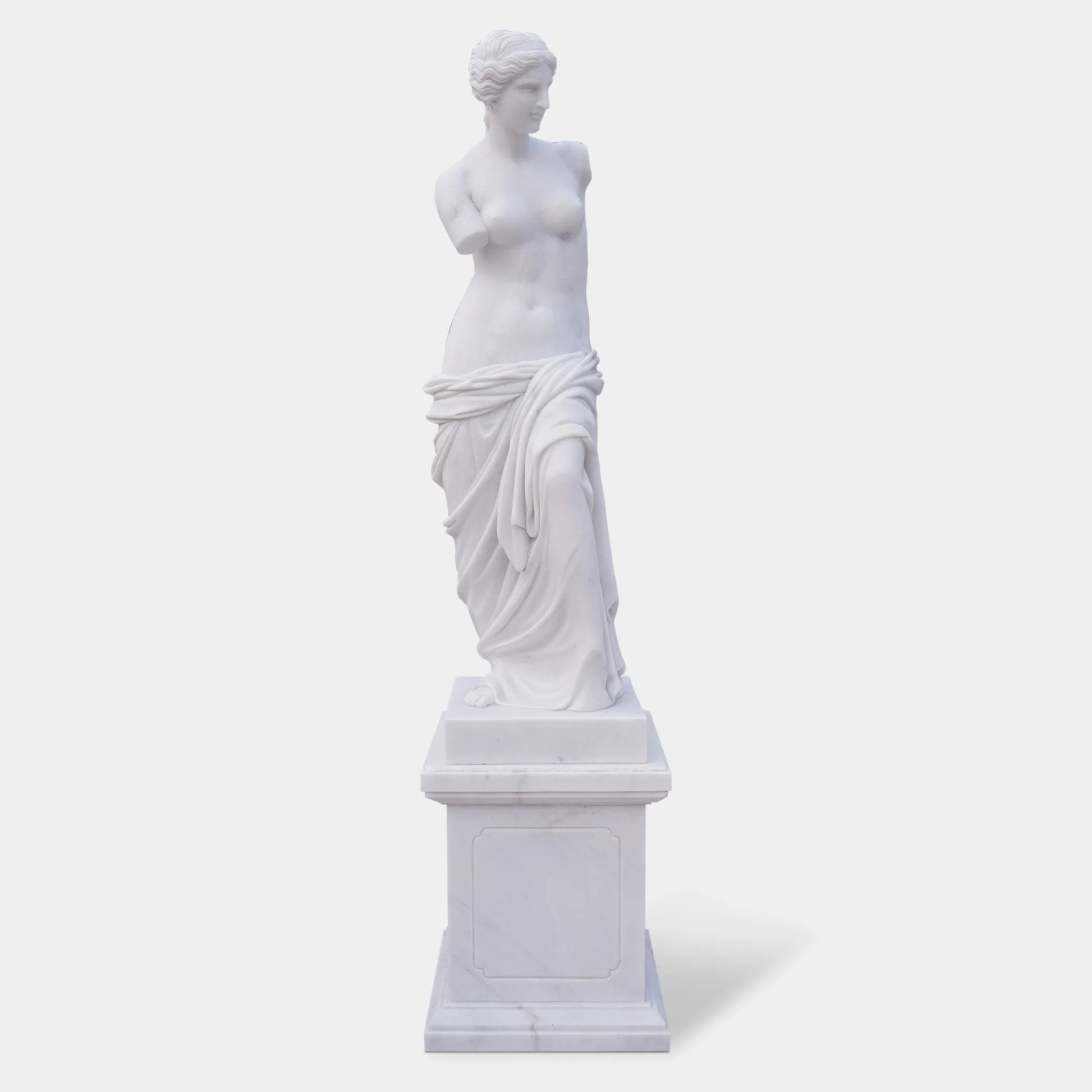 Marble sculpture of Venus de Milo with detailed Greek design standing on a pedestal.