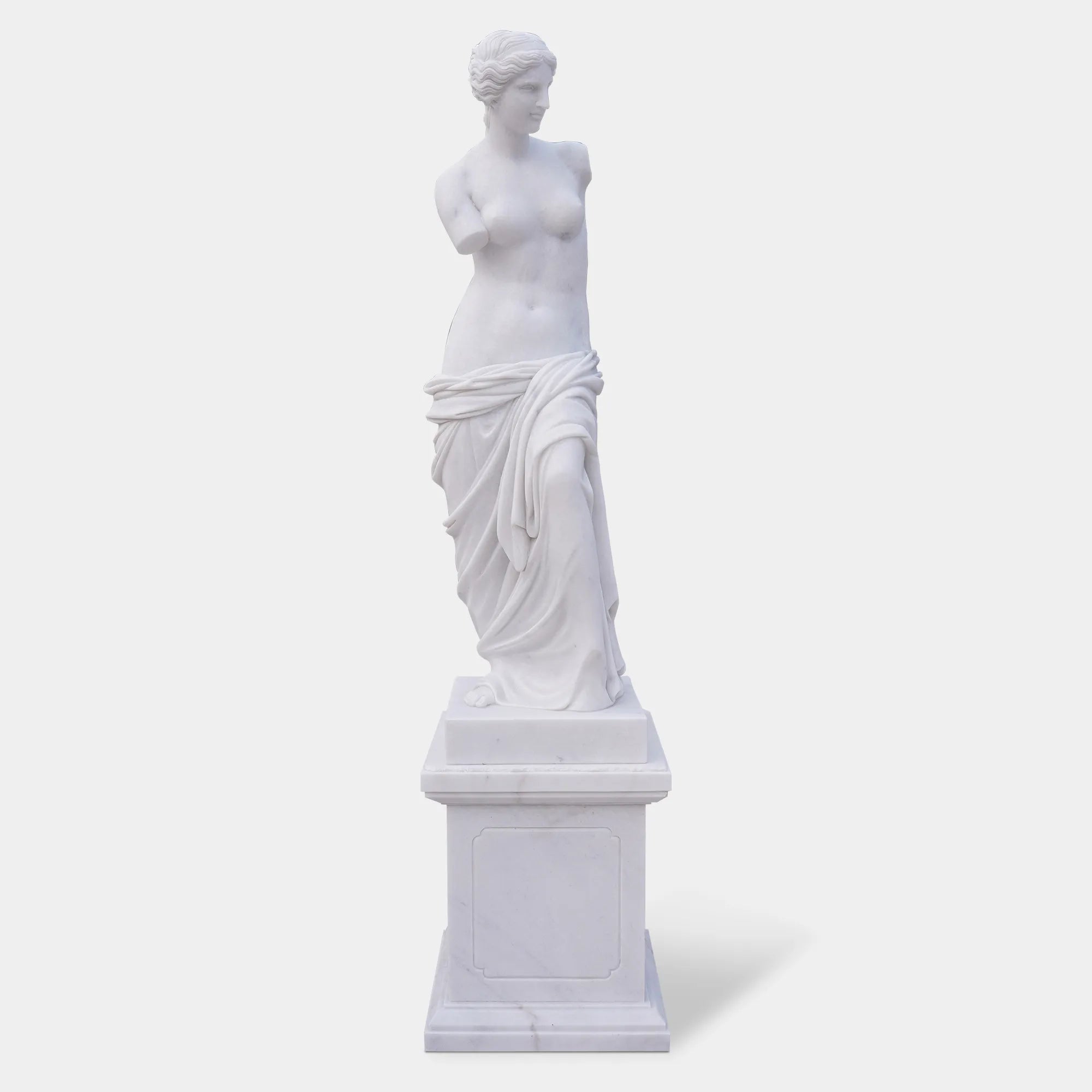 Marble sculpture of Venus de Milo with detailed Greek design standing on a pedestal.