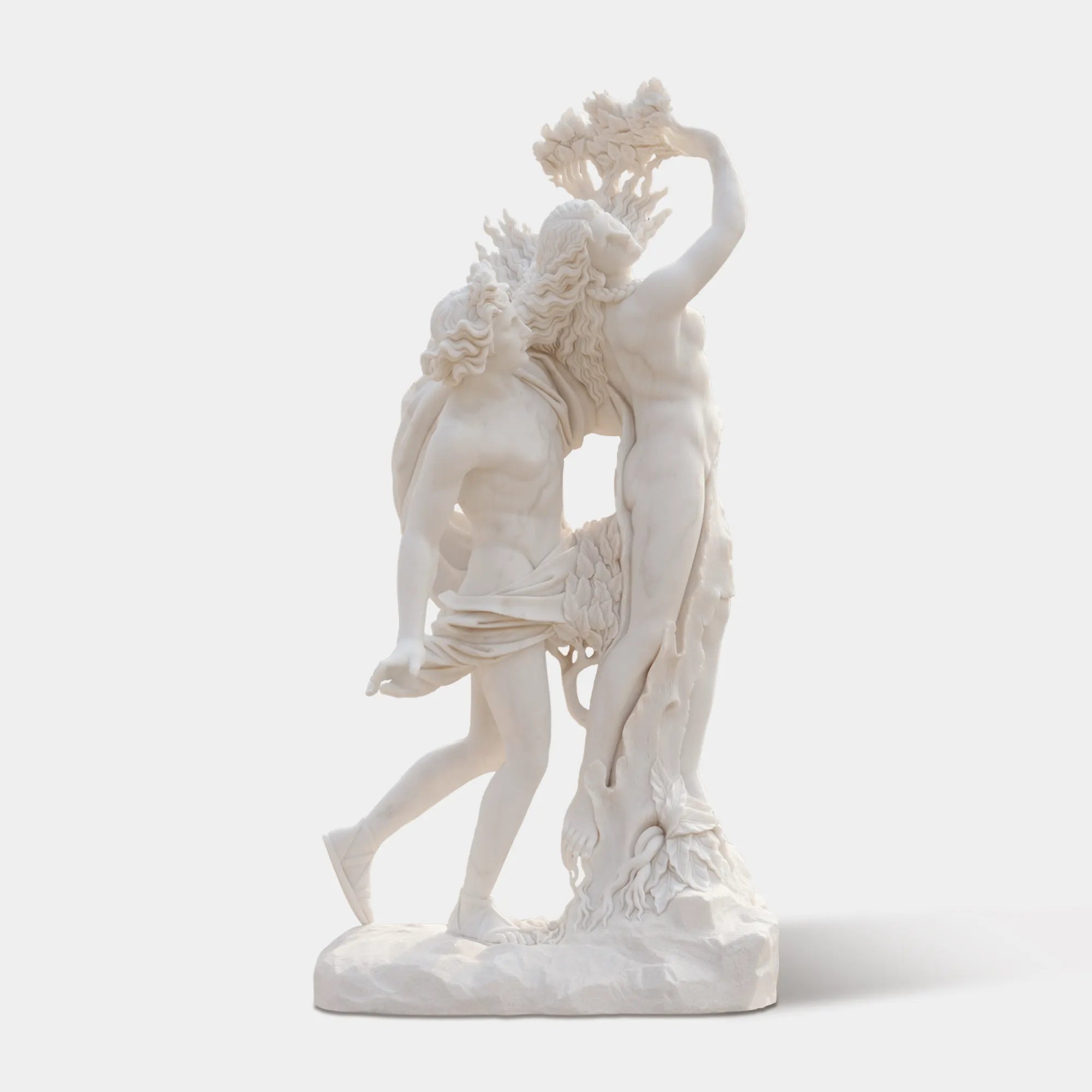 Marble sculpture of Apollo and Daphne in transformation, showing Apollo reaching for Daphne as she turns into a laurel tree, displayed outdoors in a classical courtyard with marble arches and palm trees.