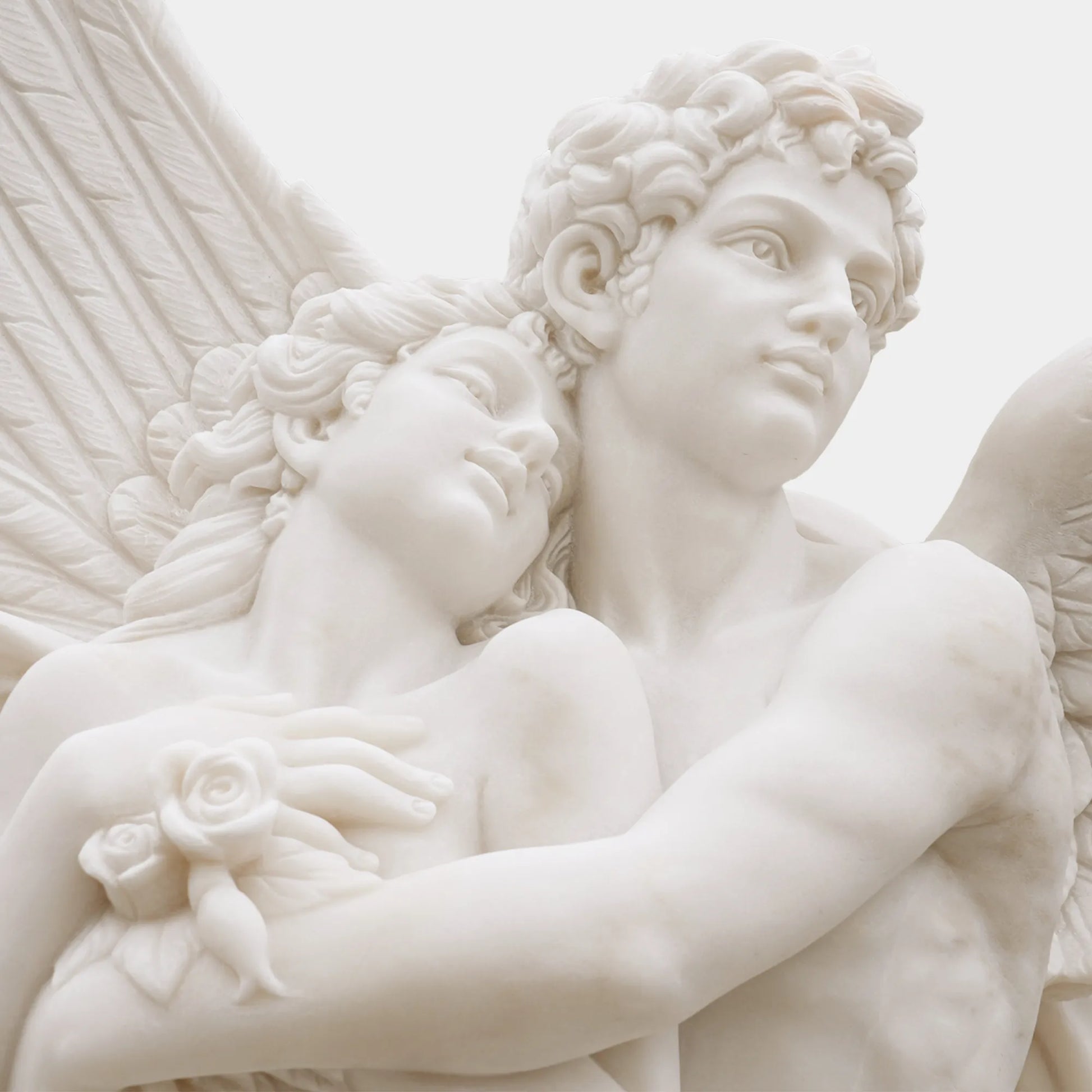 Romantic marble sculpture of Cupid and Psyche in elegant villa garden, showing detailed wings and graceful embrace under sunlight.