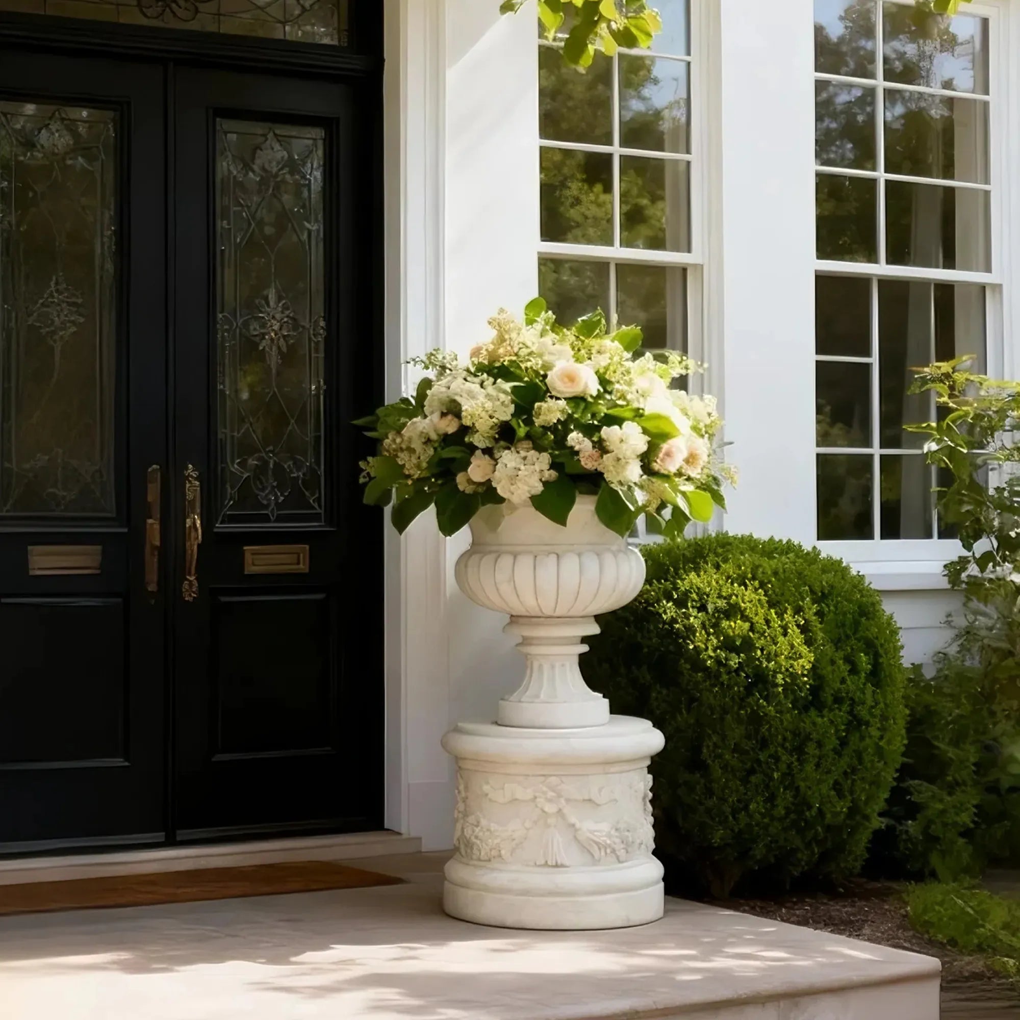 Elegant marble planter sculpture with floral motifs and rounded base design.