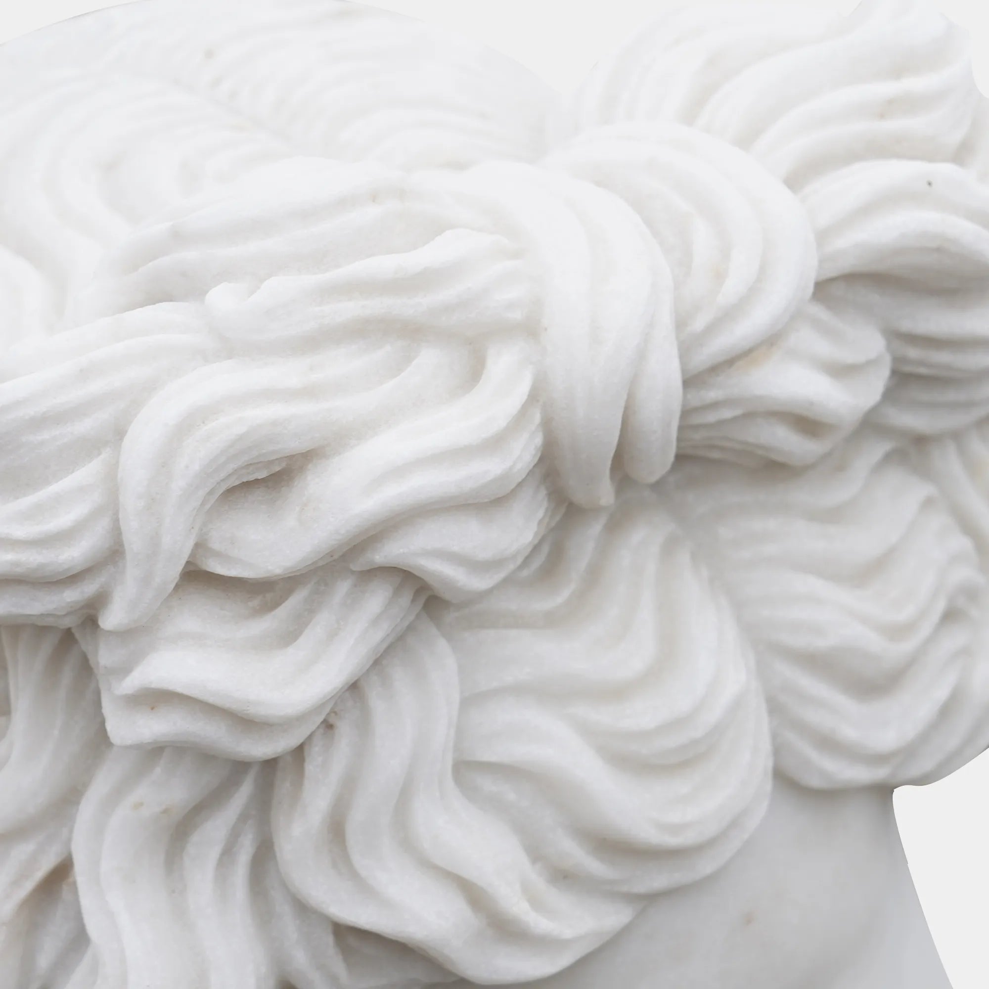 Apollo marble bust on matching pedestal photographed in a gallery interior.