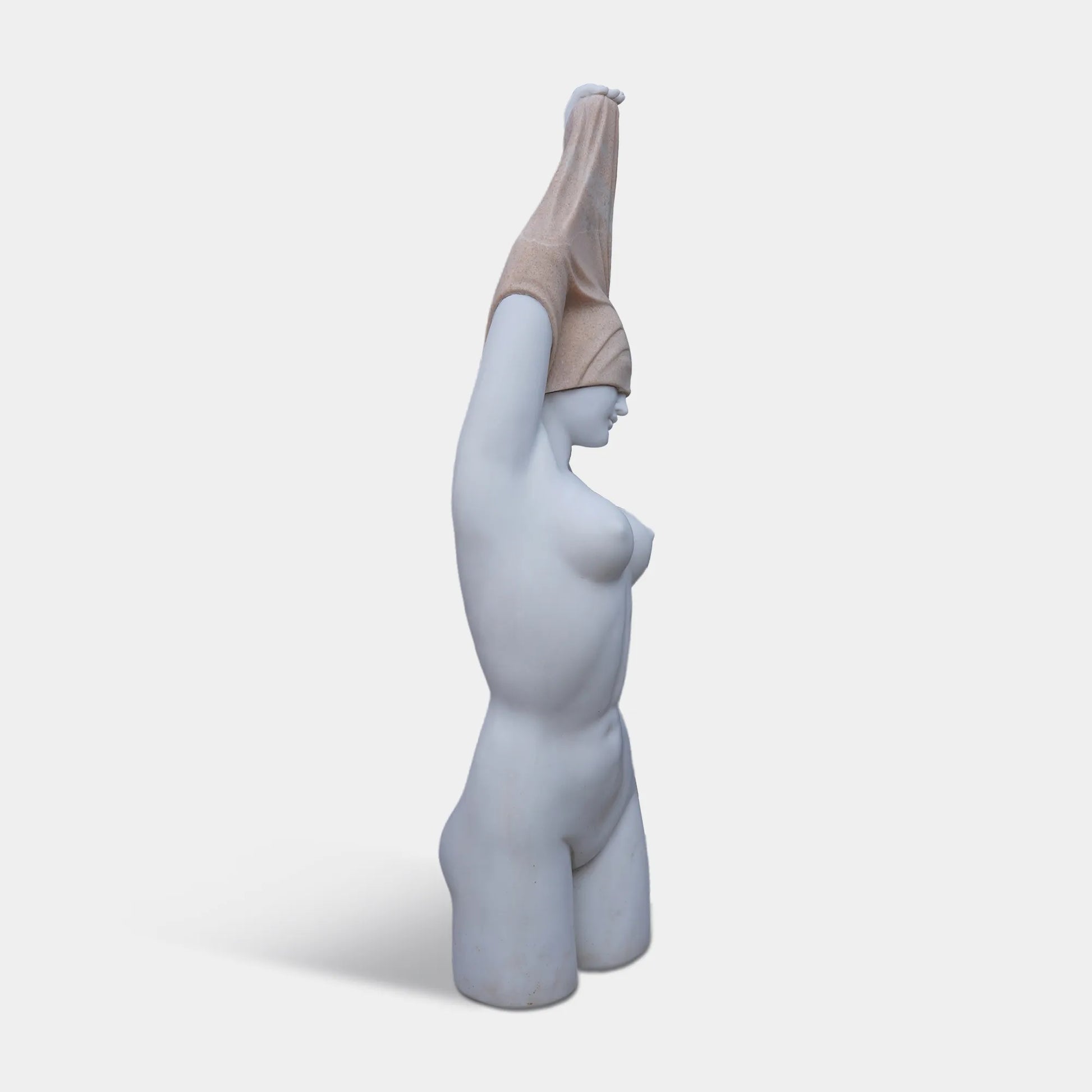 Marble female torso sculpture with raised arms and covered head on pedestal.