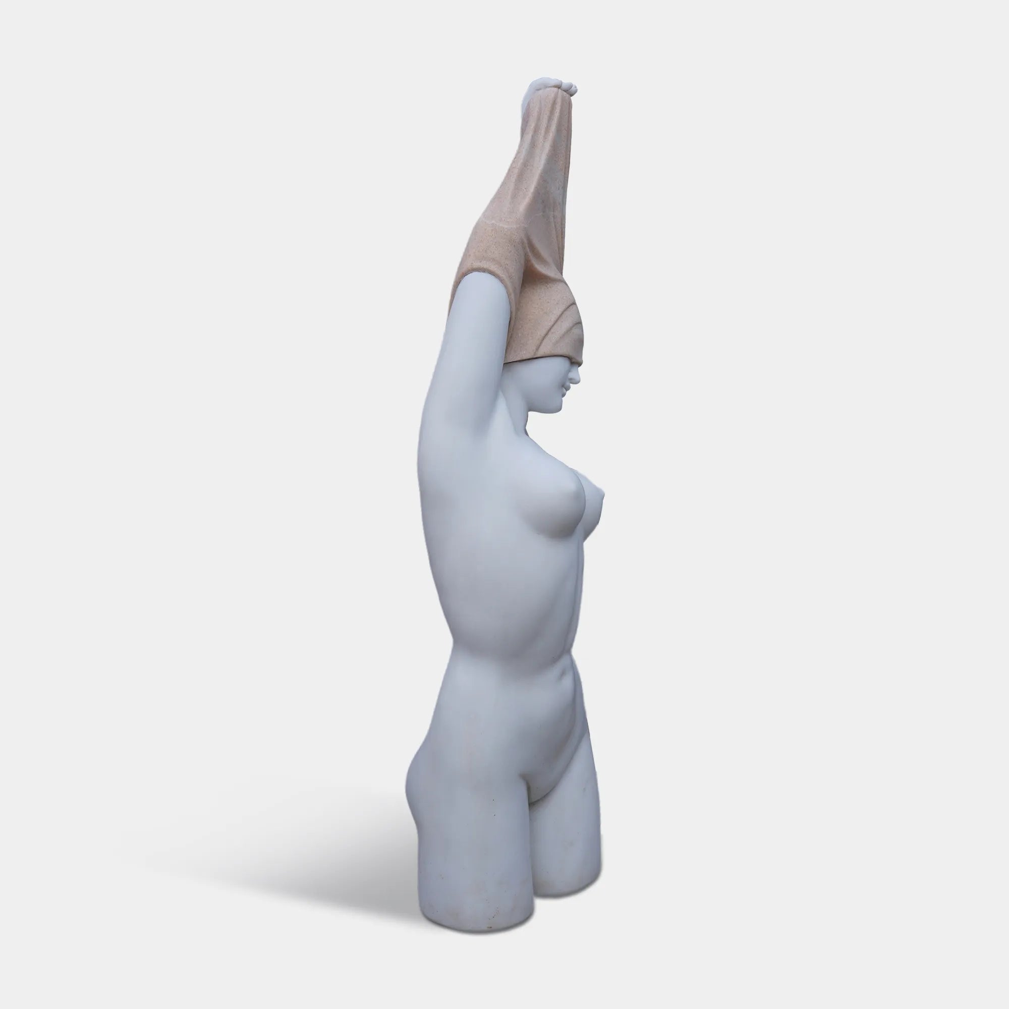Marble female torso sculpture with raised arms and covered head on pedestal.