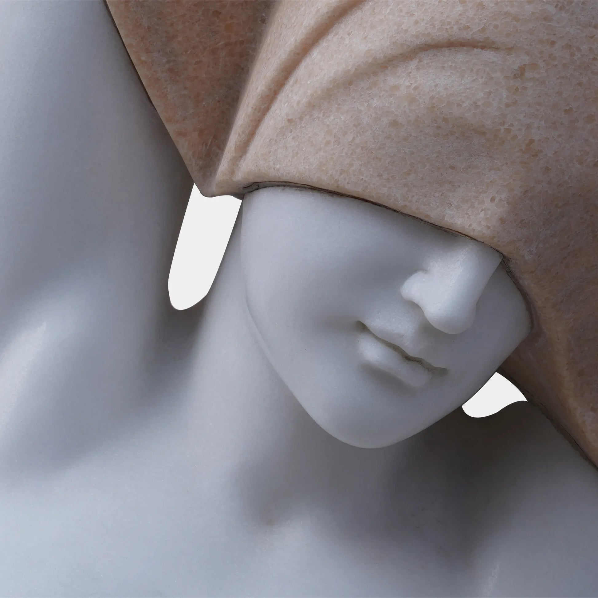 Marble female torso sculpture with raised arms and covered head on pedestal.