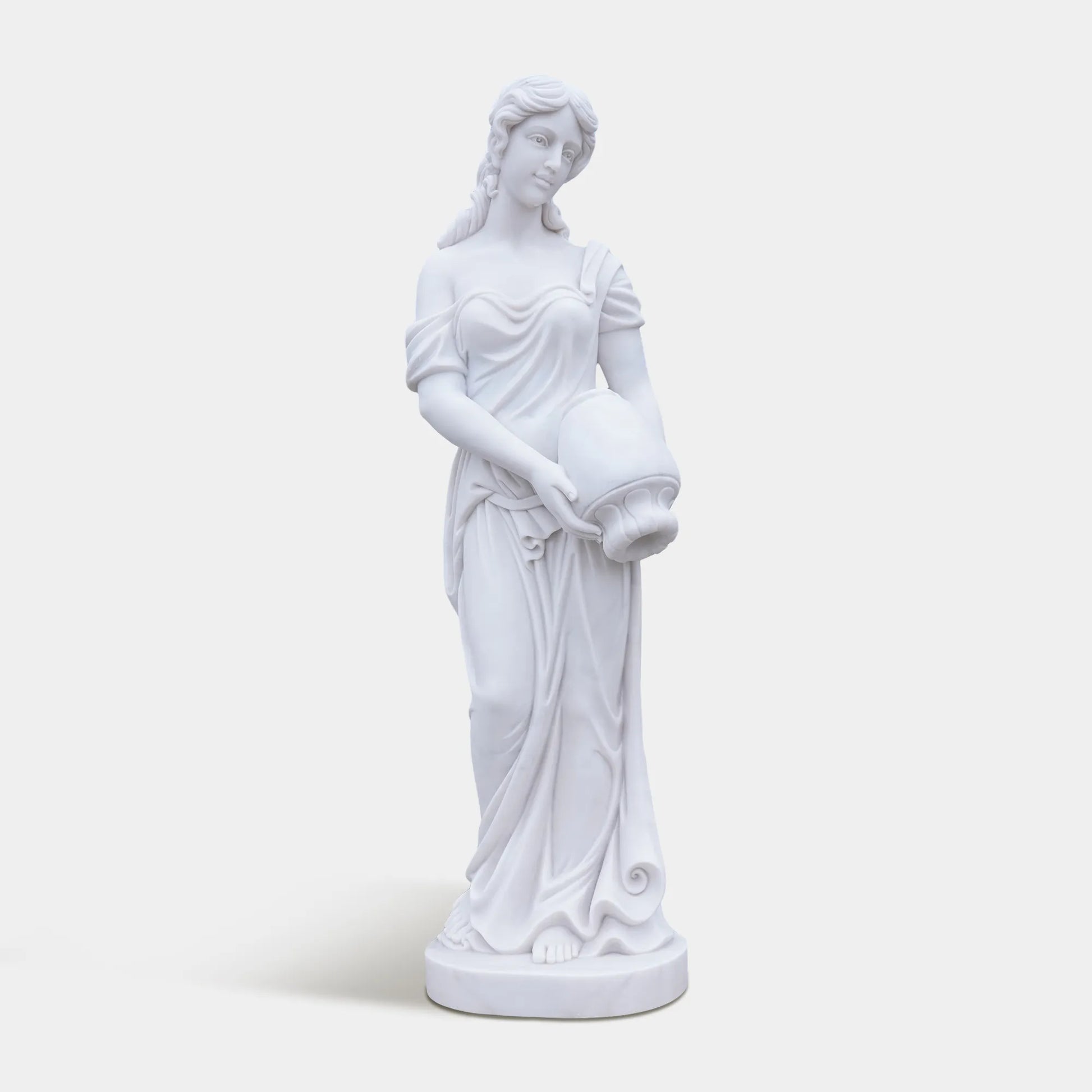 Marble female statue holding a vessel in a garden setting.