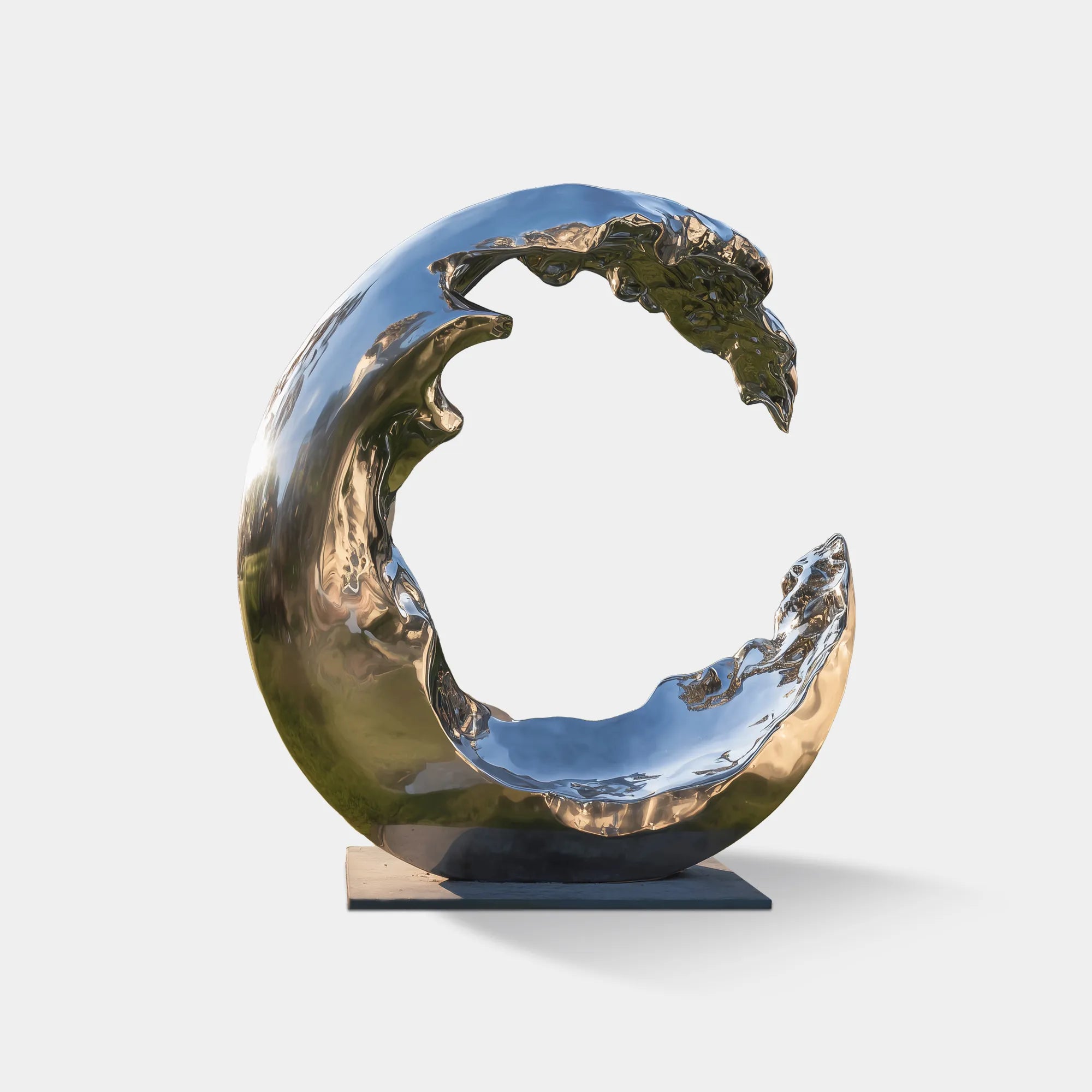 Mirror-finish stainless steel wave sculpture positioned in a landscaped outdoor area.