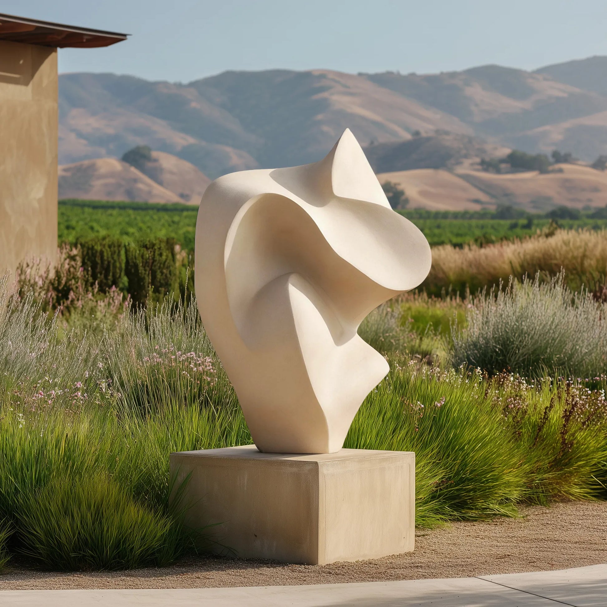 Abstract stainless steel sculpture with smooth curved form on pedestal.