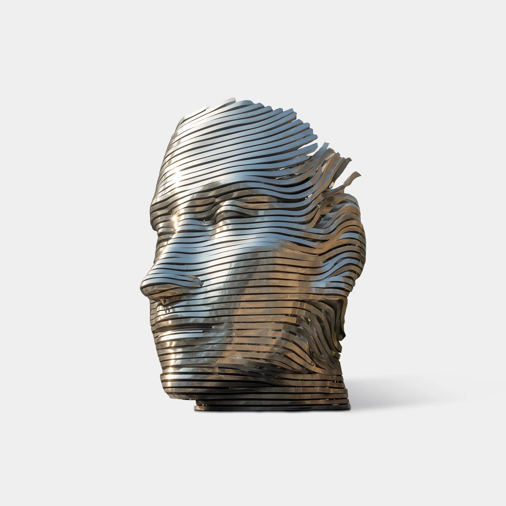 Stainless steel layered head sculpture with horizontal metal strips in outdoor plaza.