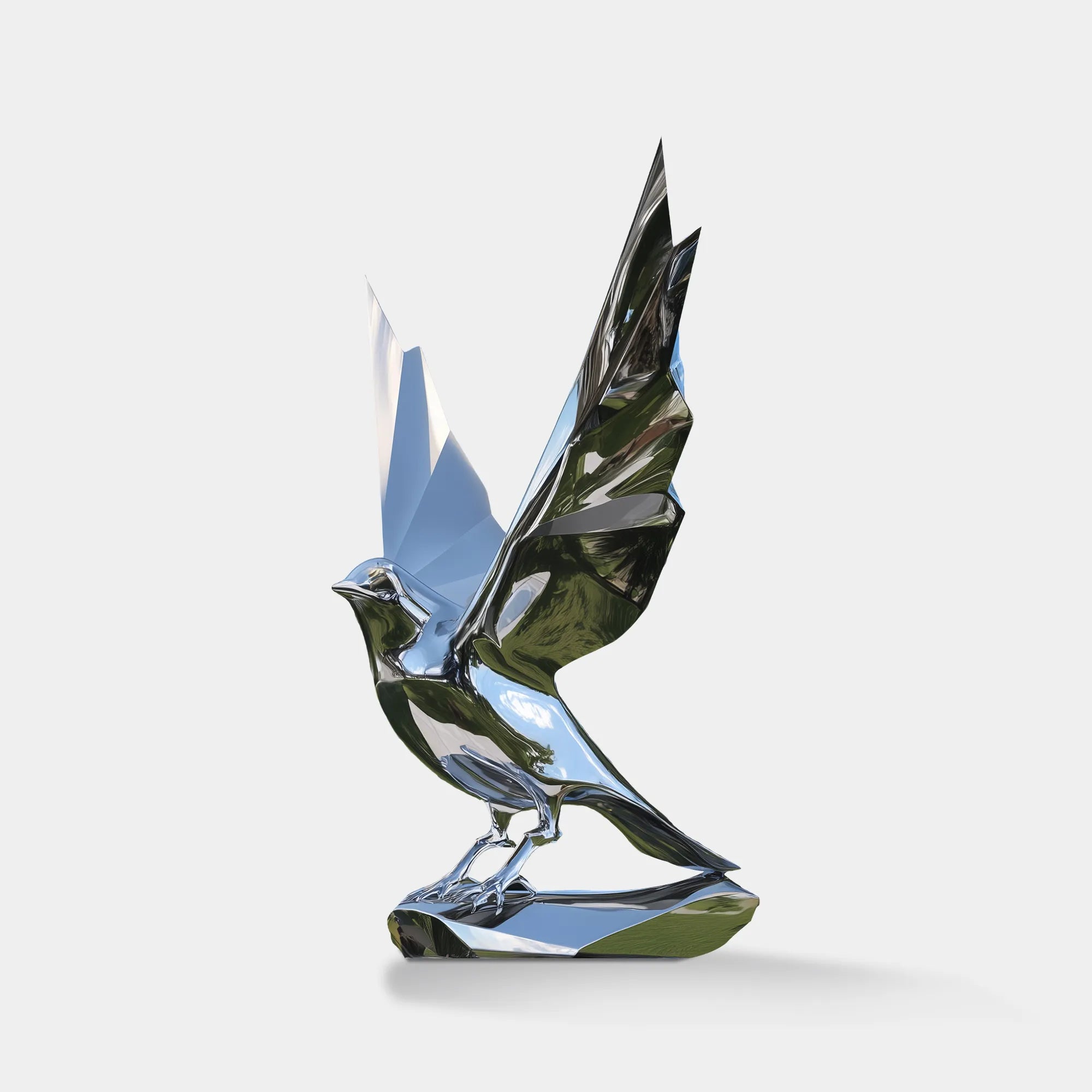 Stainless steel bird sculpture with raised wings on pedestal.