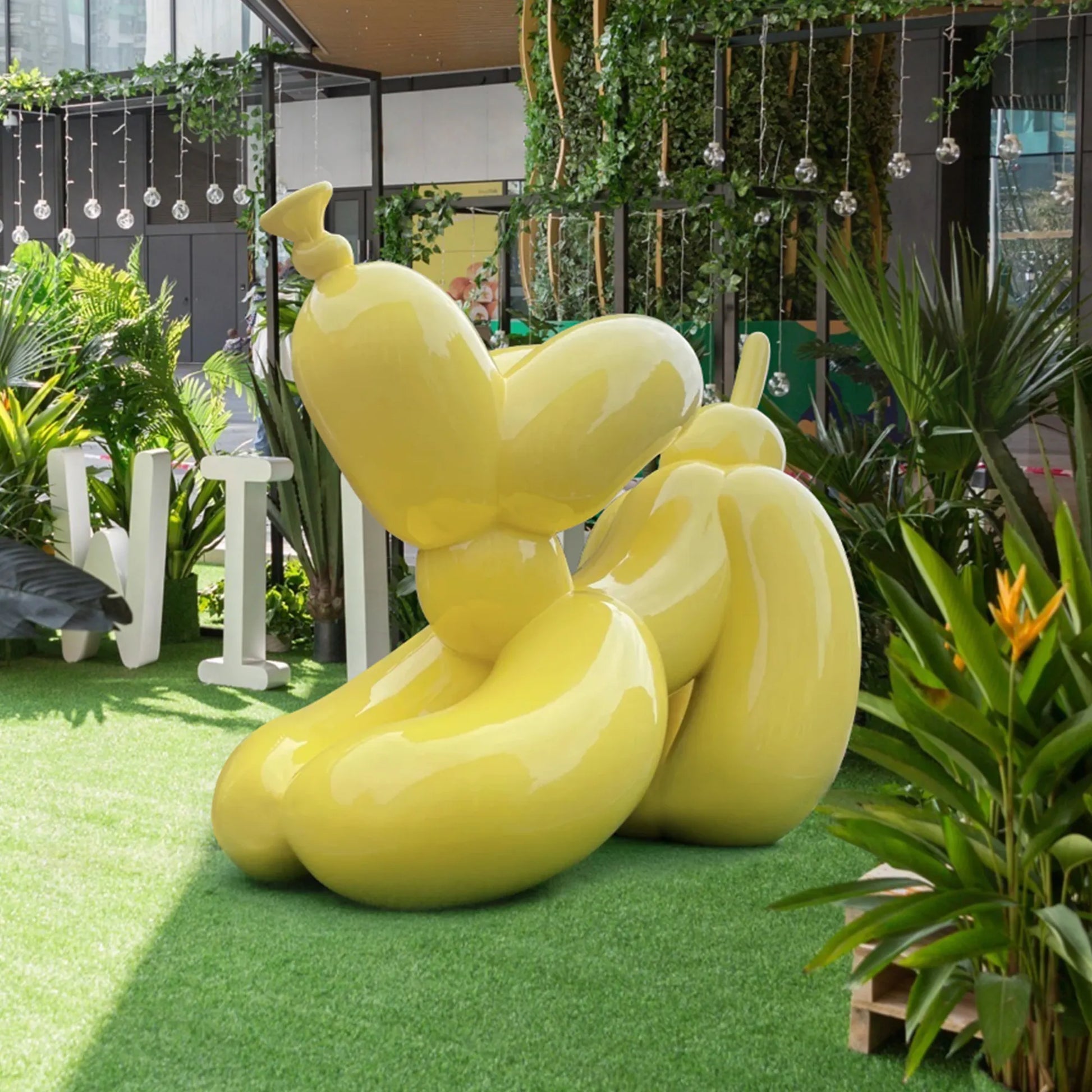 Custom stainless steel sculpture in a yellow balloon dog design for gardens.