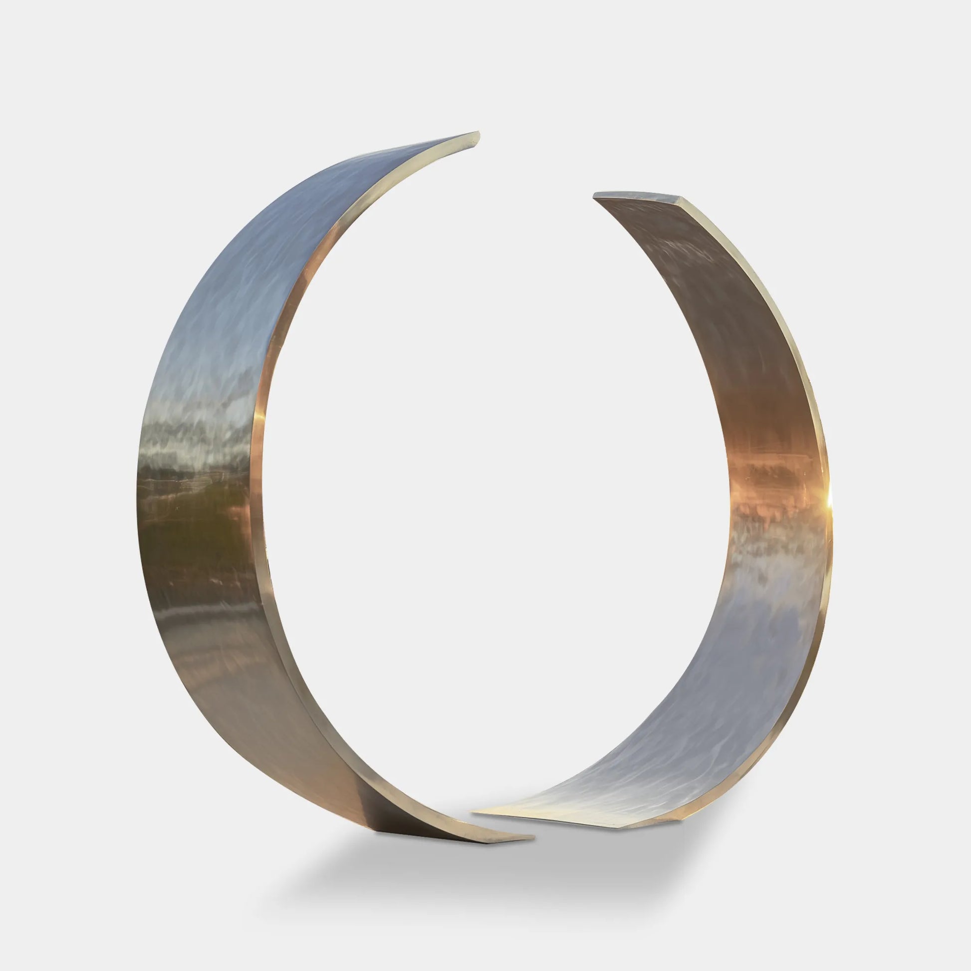 Stainless steel ring sculpture with two separate arcs in a contemporary design for parks and plazas.
