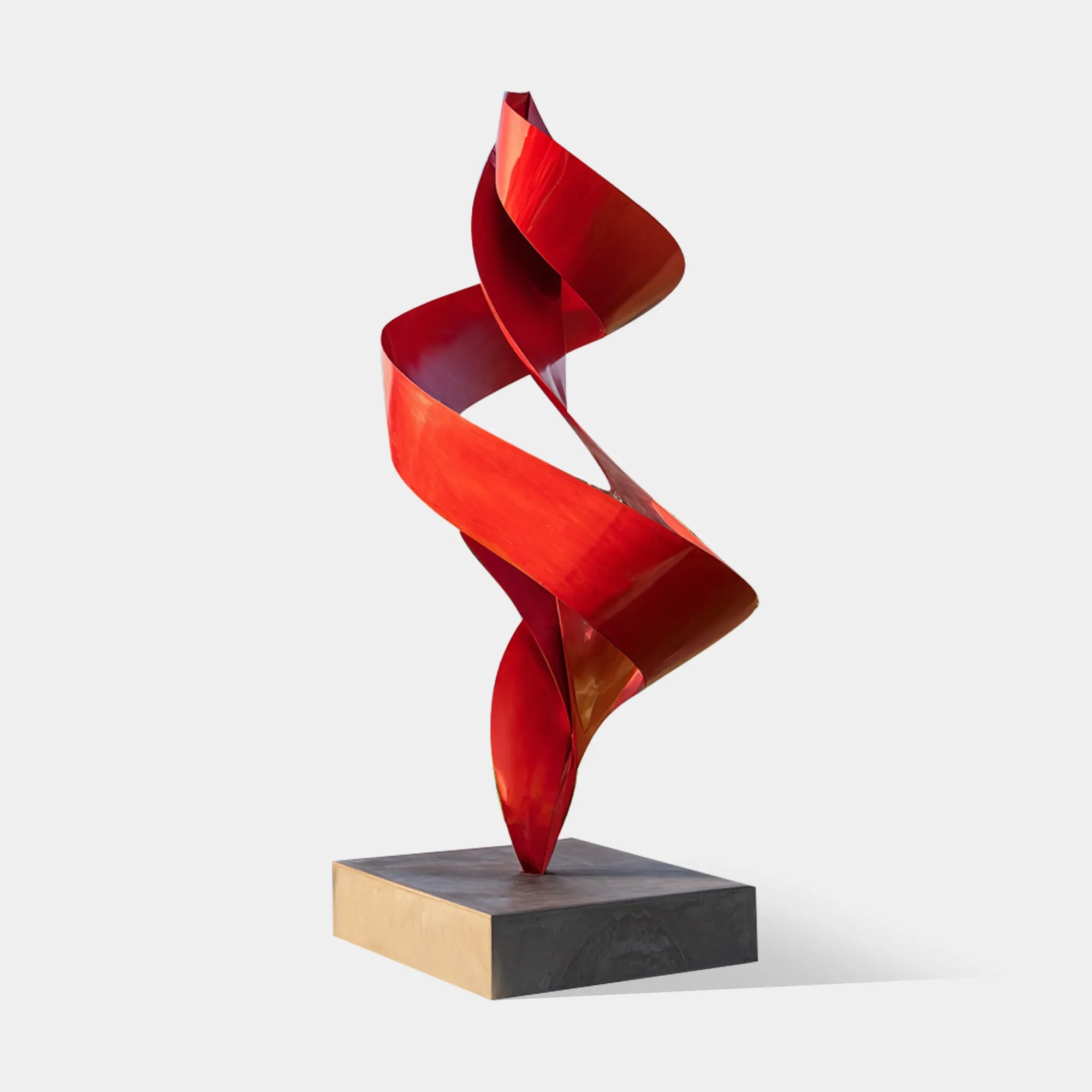 Red abstract sculpture in stainless steel with modern design for outdoor spaces.