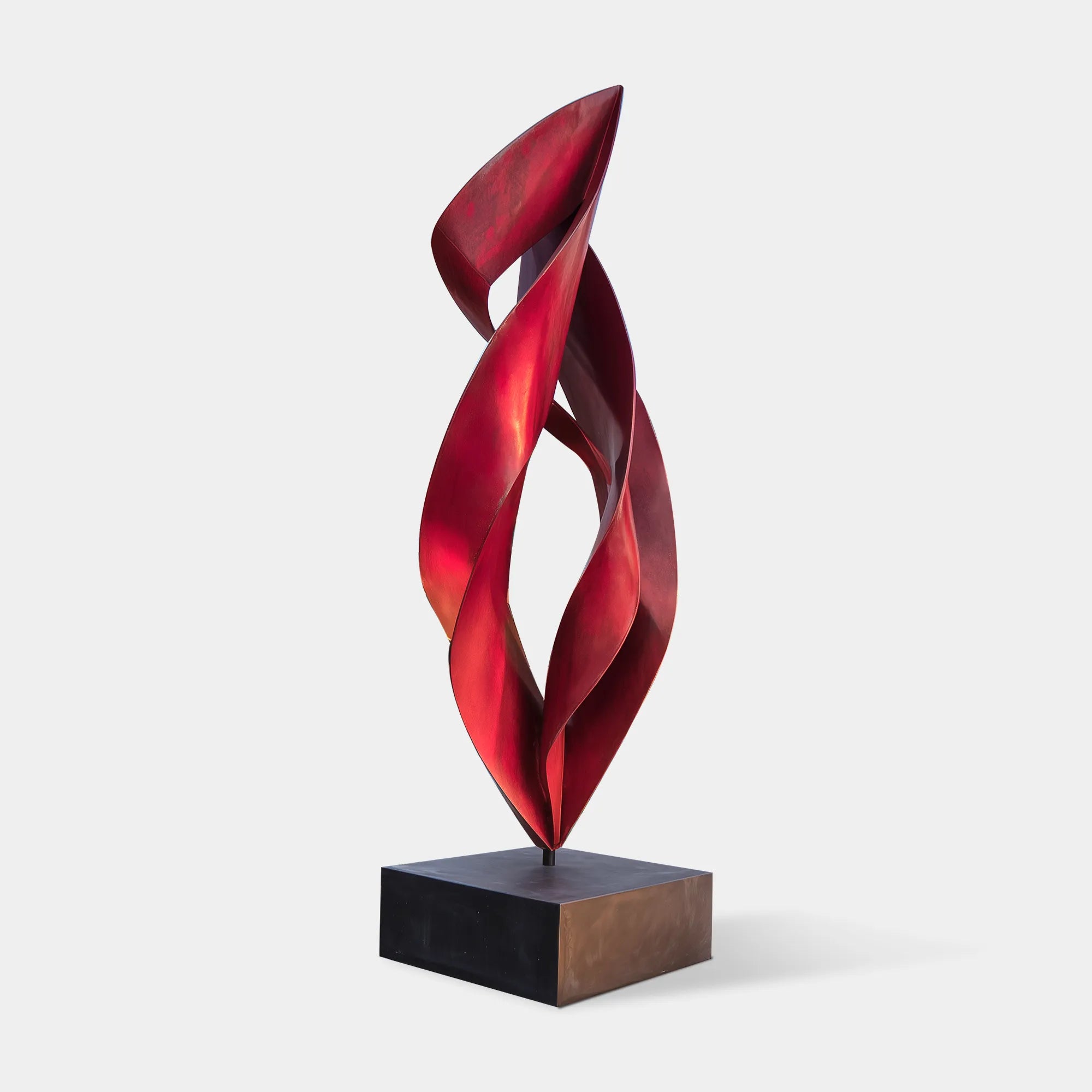 Abstract spiral sculpture in stainless steel with flame inspired ribbon design for luxury villas.