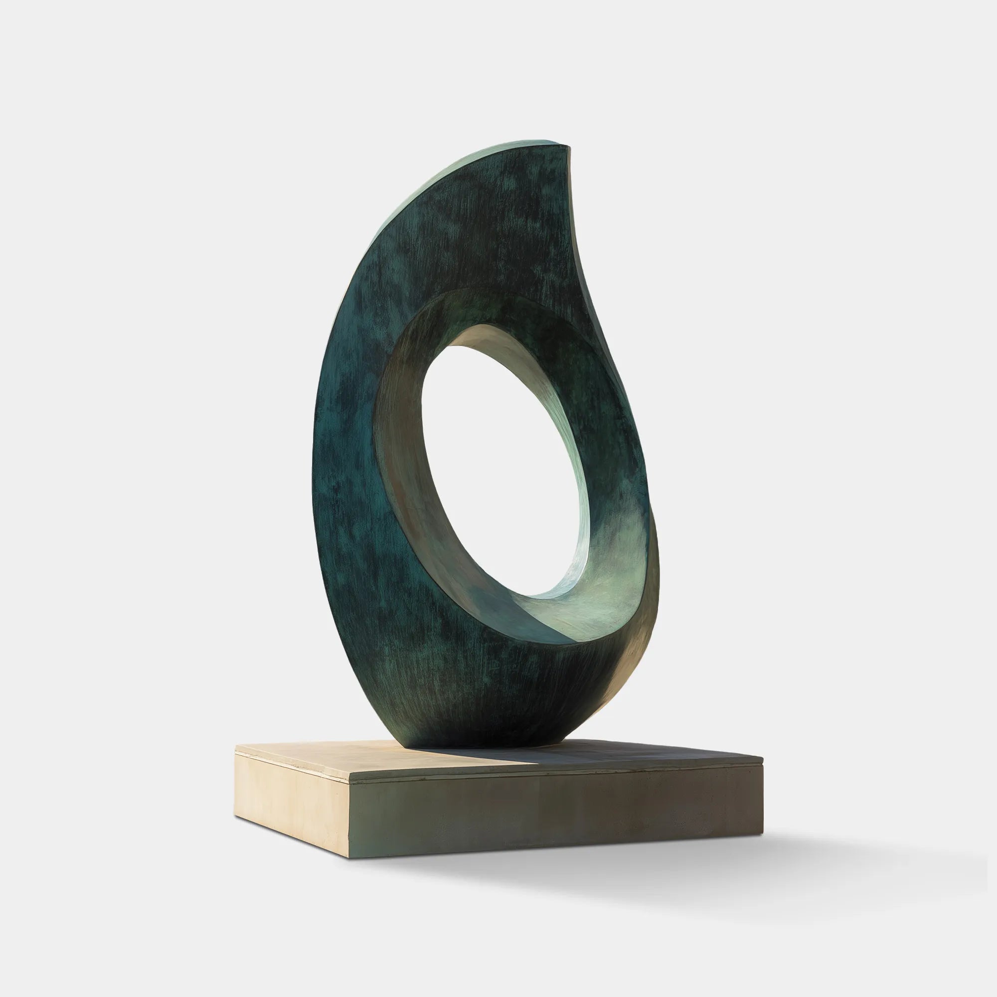 Patinated bronze oval sculpture with hollow center displayed outdoors near a pool