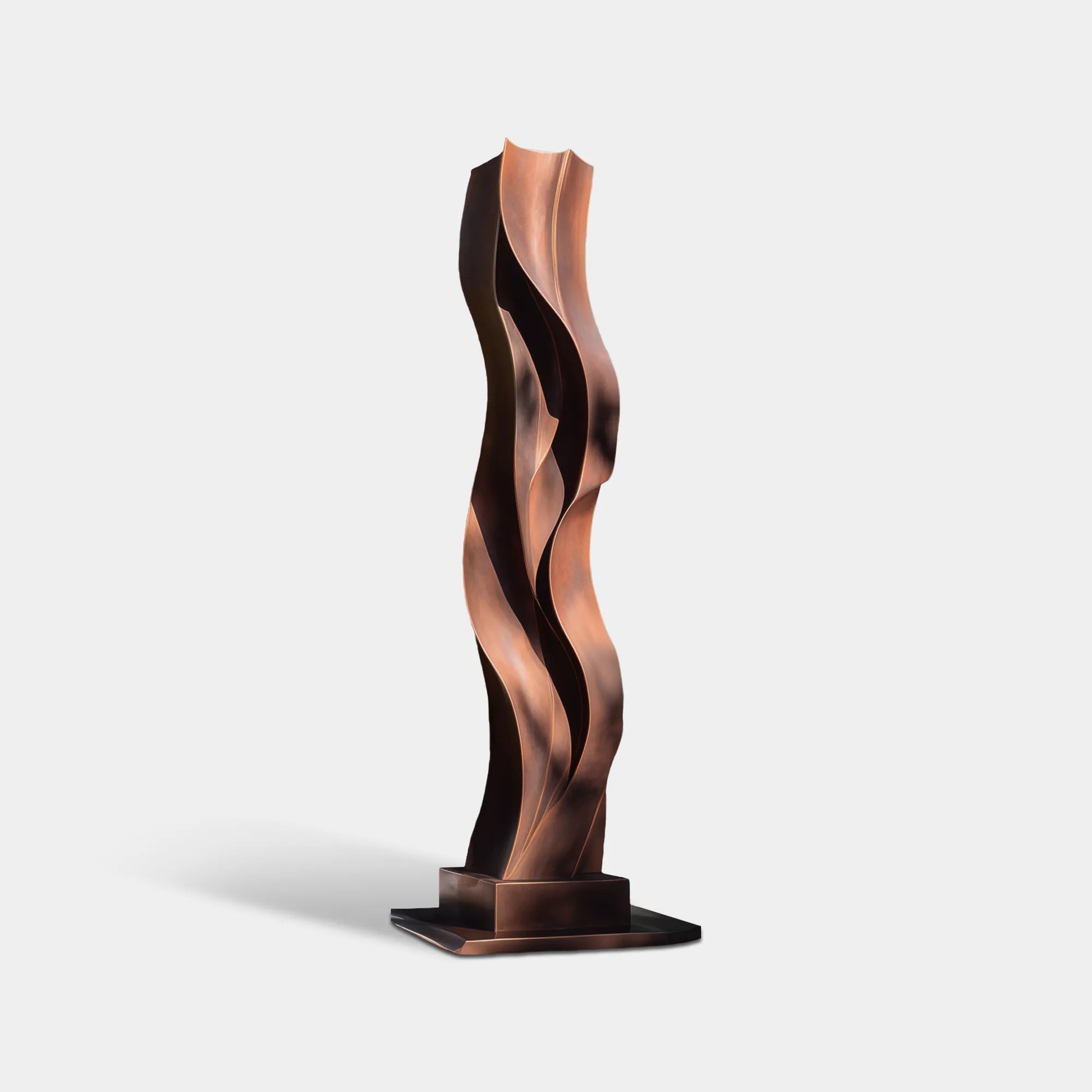 Bronze outdoor sculpture with layered wave form placed in a modern garden.