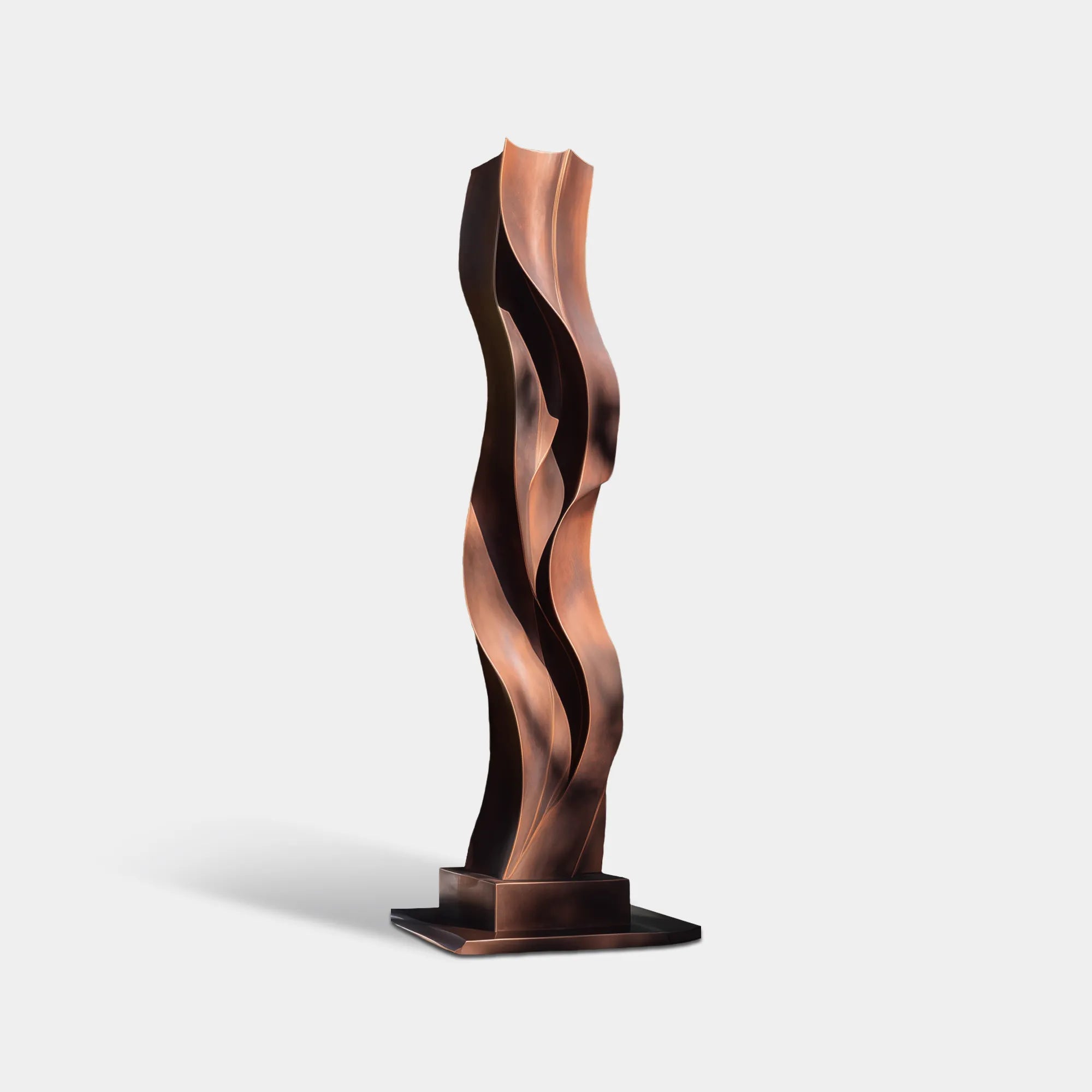 Bronze outdoor sculpture with layered wave form placed in a modern garden.