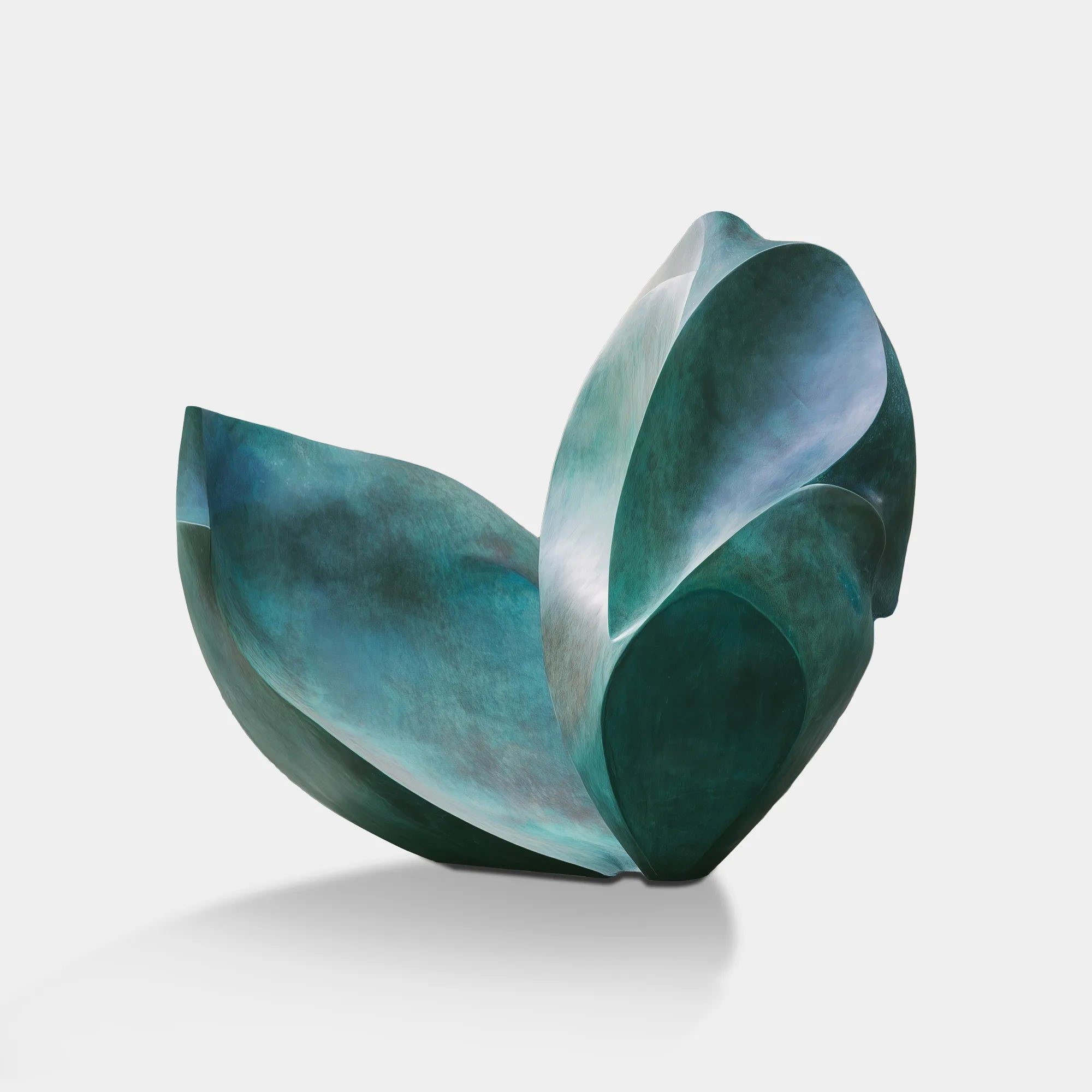 Abstract bronze organic form sculpture on stone base in corporate lobby atrium with glass walls and water feature