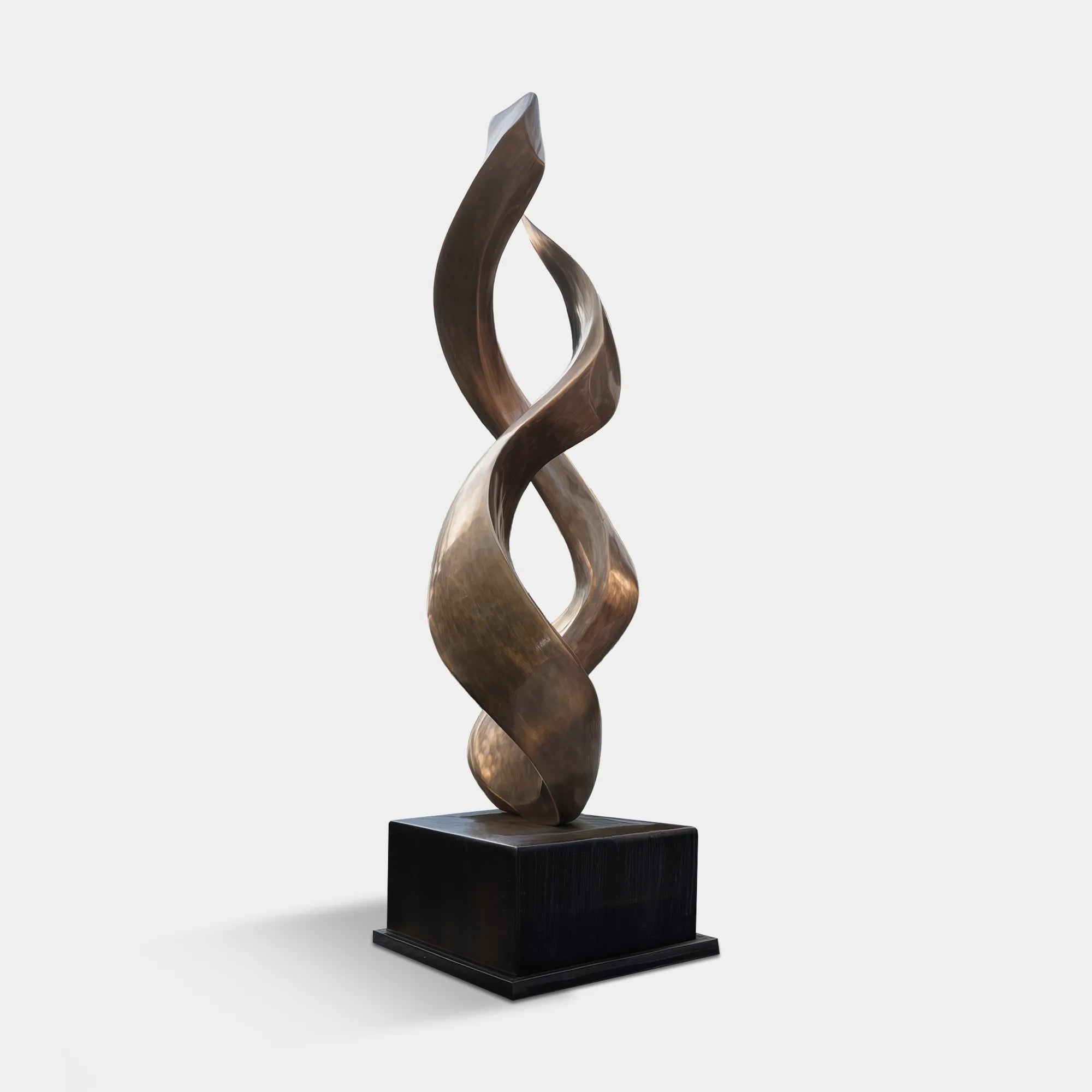 Bronze abstract flowing form sculpture in courtyard pond near modern villa entrance.
