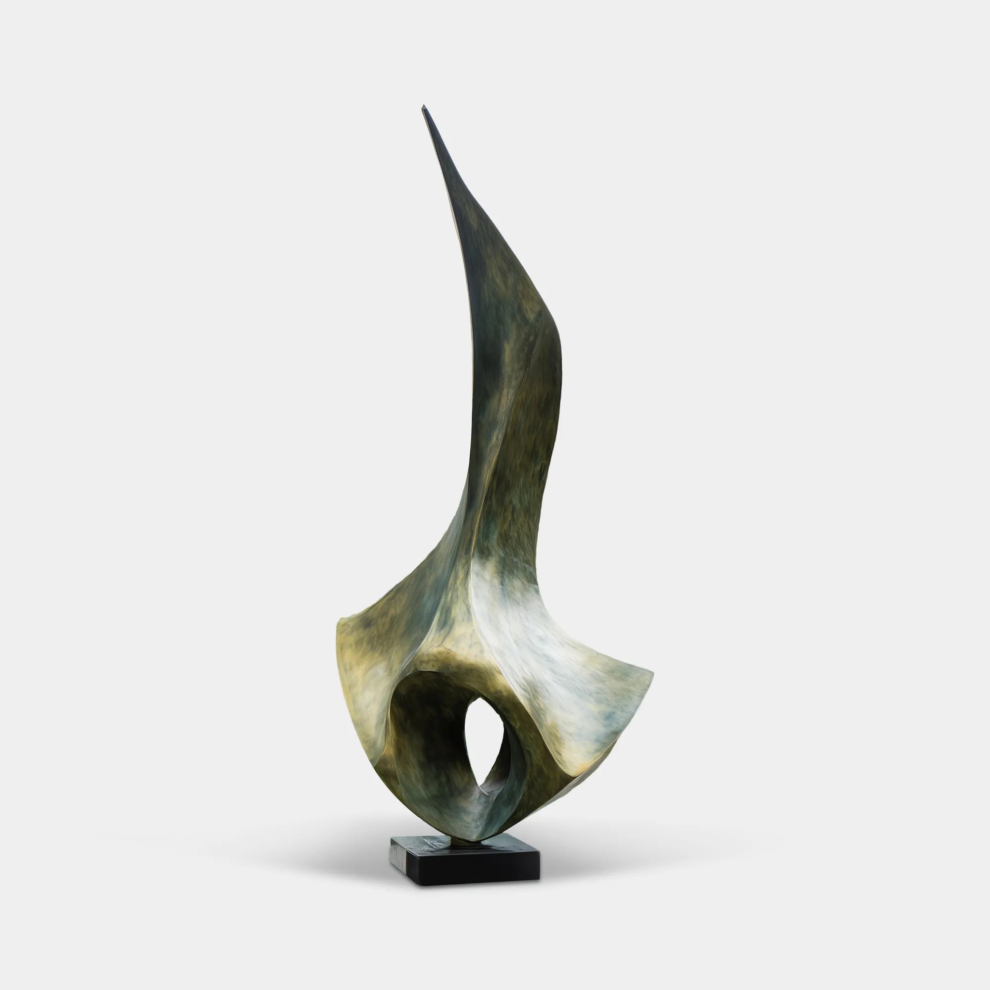 Bronze abstract sculpture beside a modern villa courtyard with glass walls and forest landscaping.