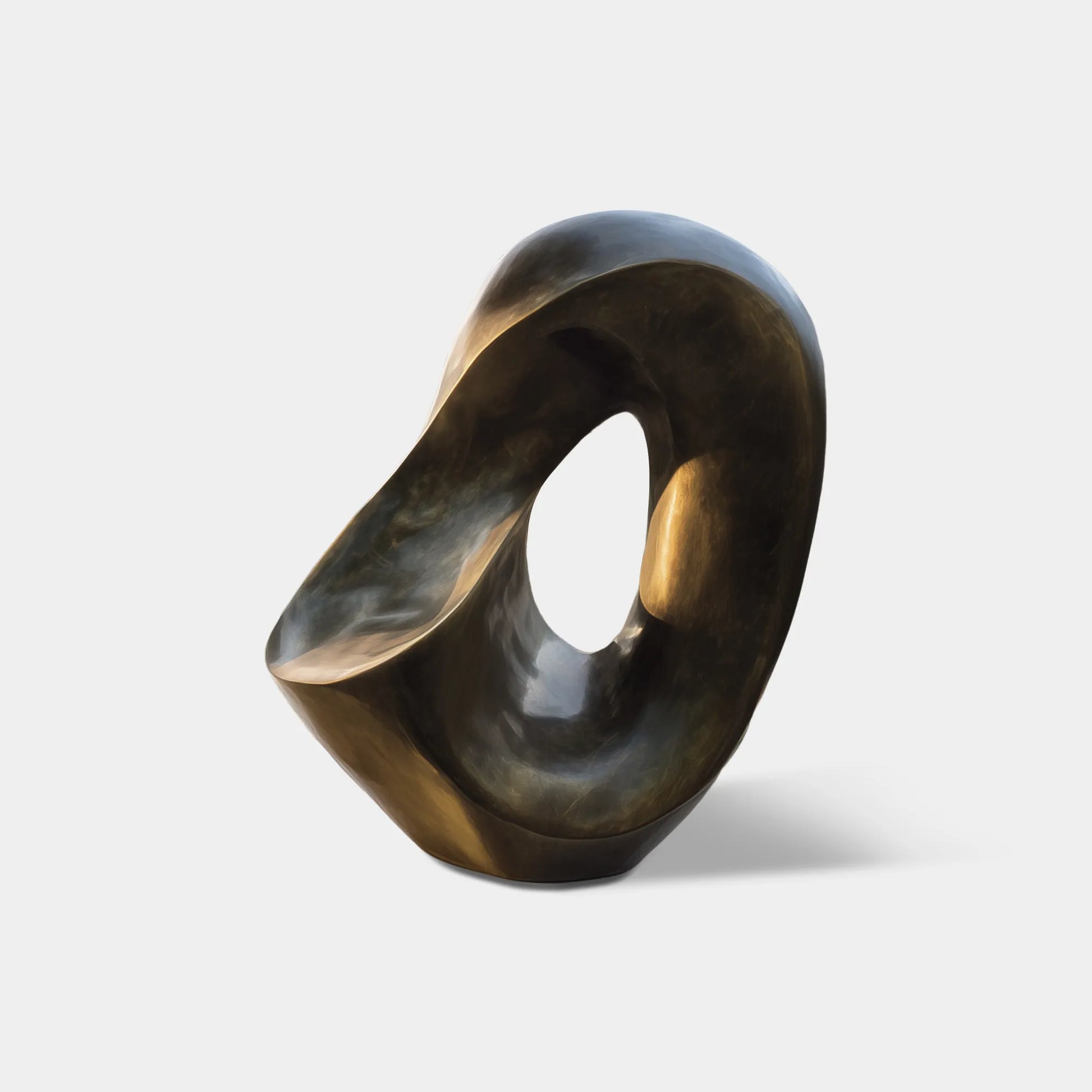 Dark bronze abstract sculpture with an open organic shape on a stone base in a modern villa courtyard.