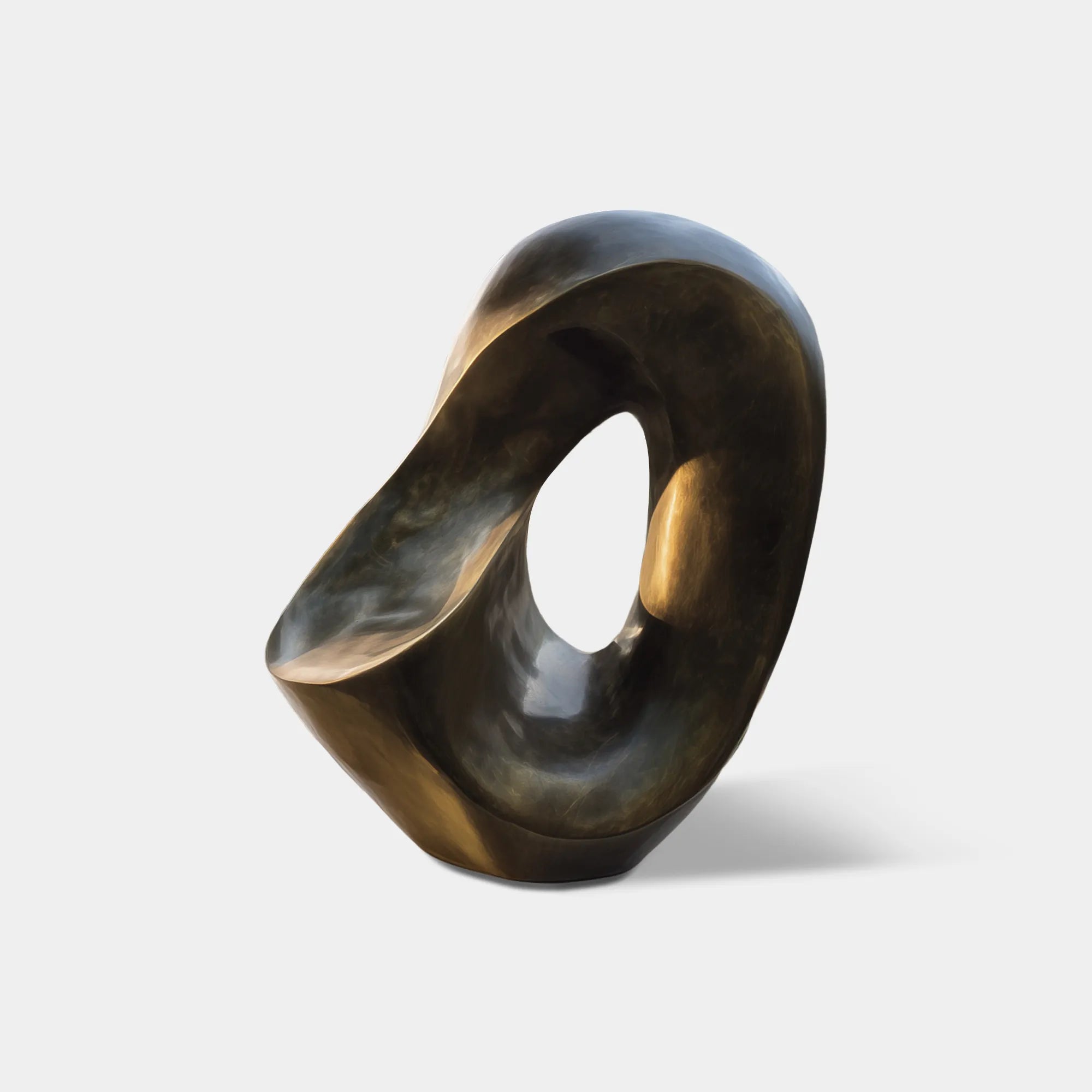 Dark bronze abstract sculpture with an open organic shape on a stone base in a modern villa courtyard.