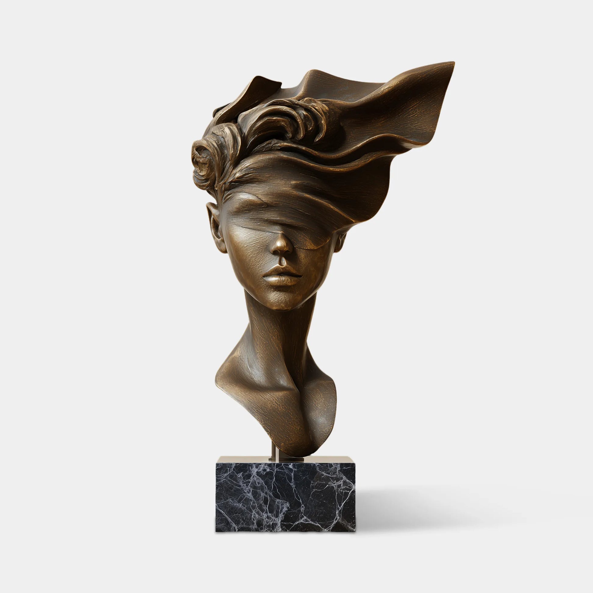 A bronze bust sculpture of a blindfolded woman rests on a marble base, bathed in warm indoor light.