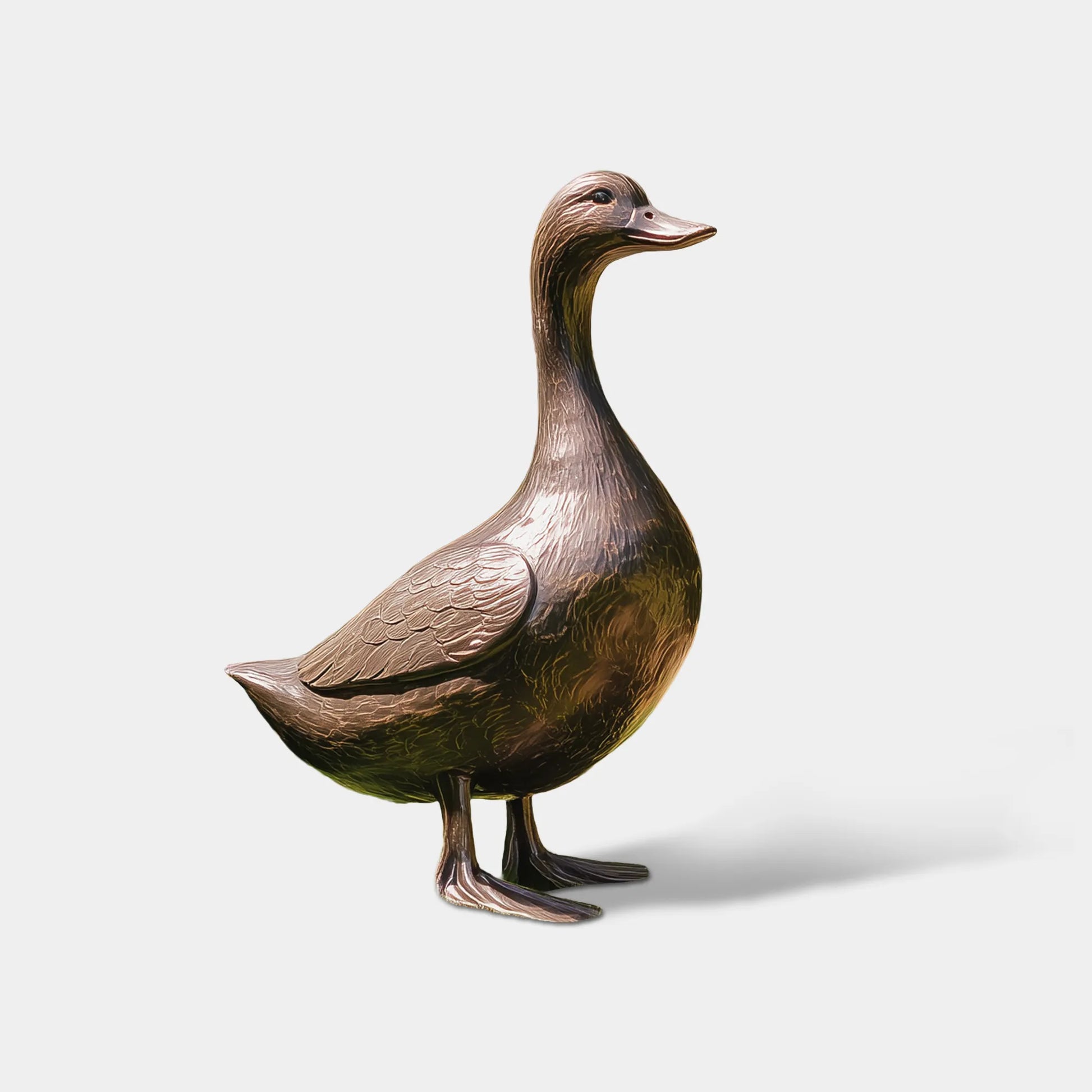 A bronze standing duck sculpture sits on green front lawn lined with lavender beside a home front door.