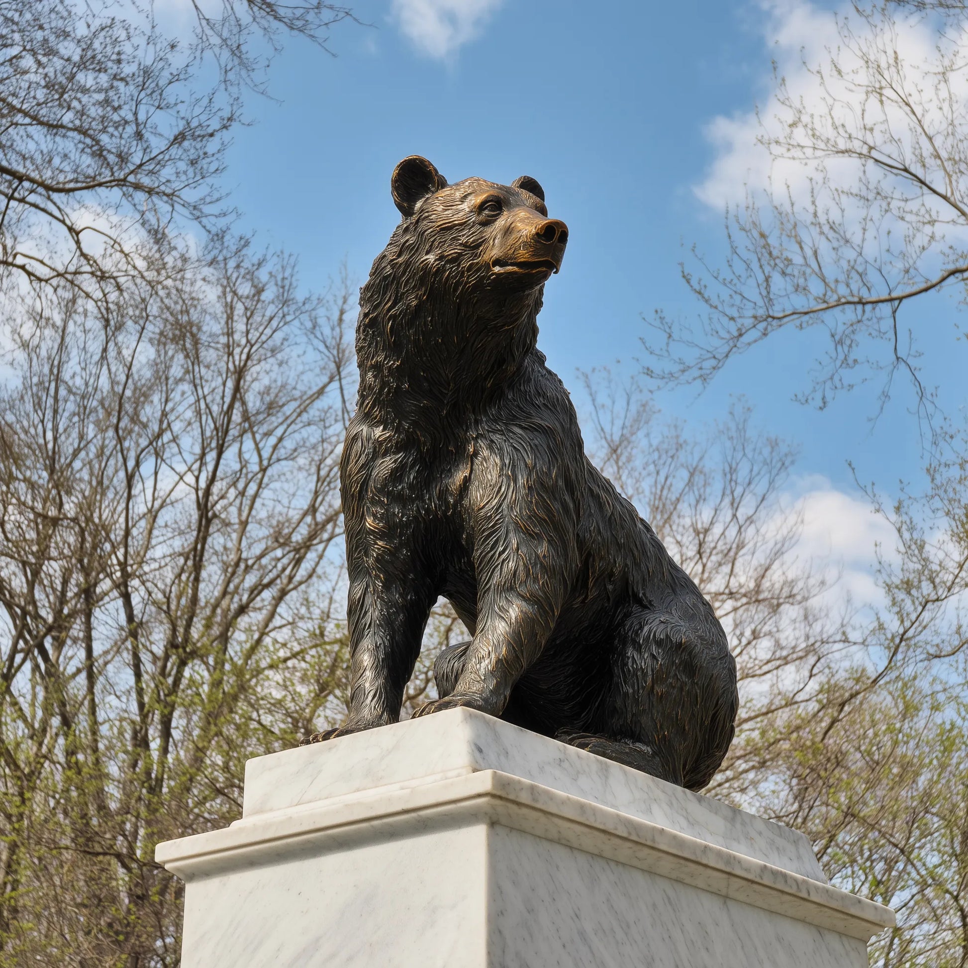 Bronze bear statue standing in an estate entrance.