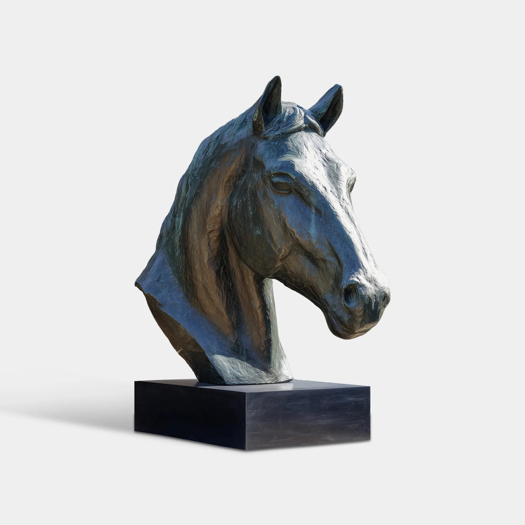 Bronze horse head sculpture with detailed mane and expressive face in close-up in a courtyard. 